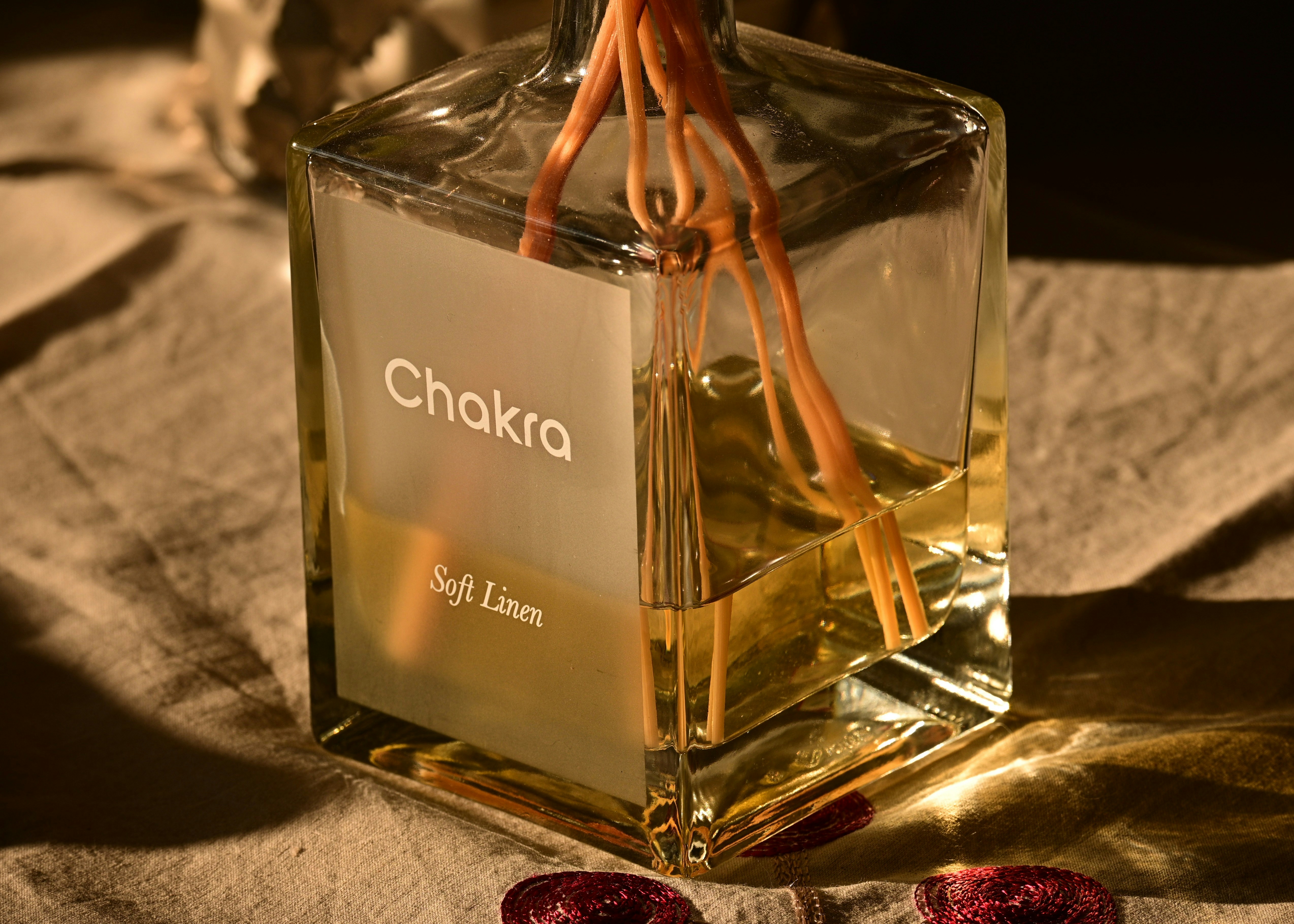 A bottle of chakra diffuser with reeds.