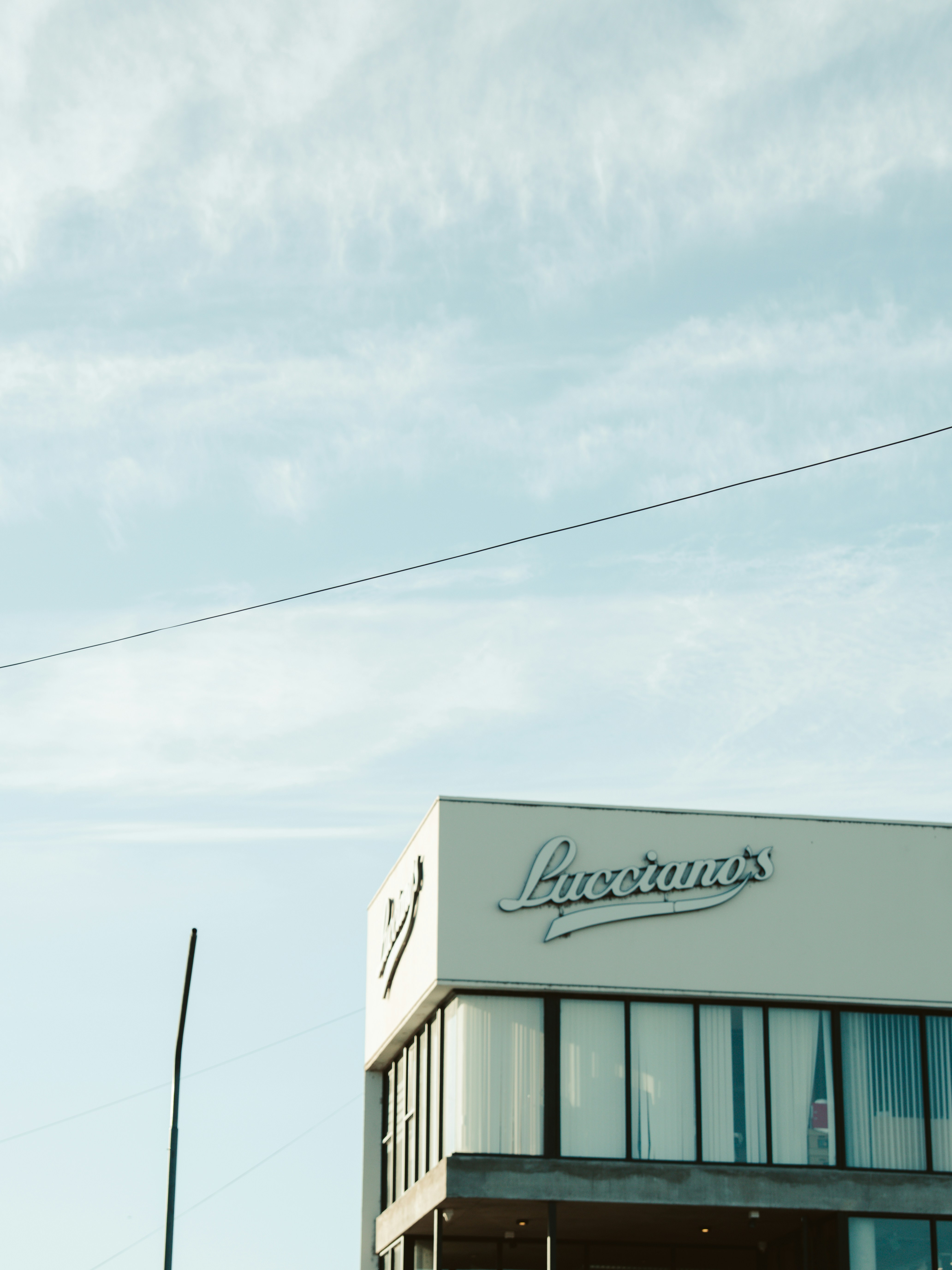 Luciano's restaurant is seen under a blue sky