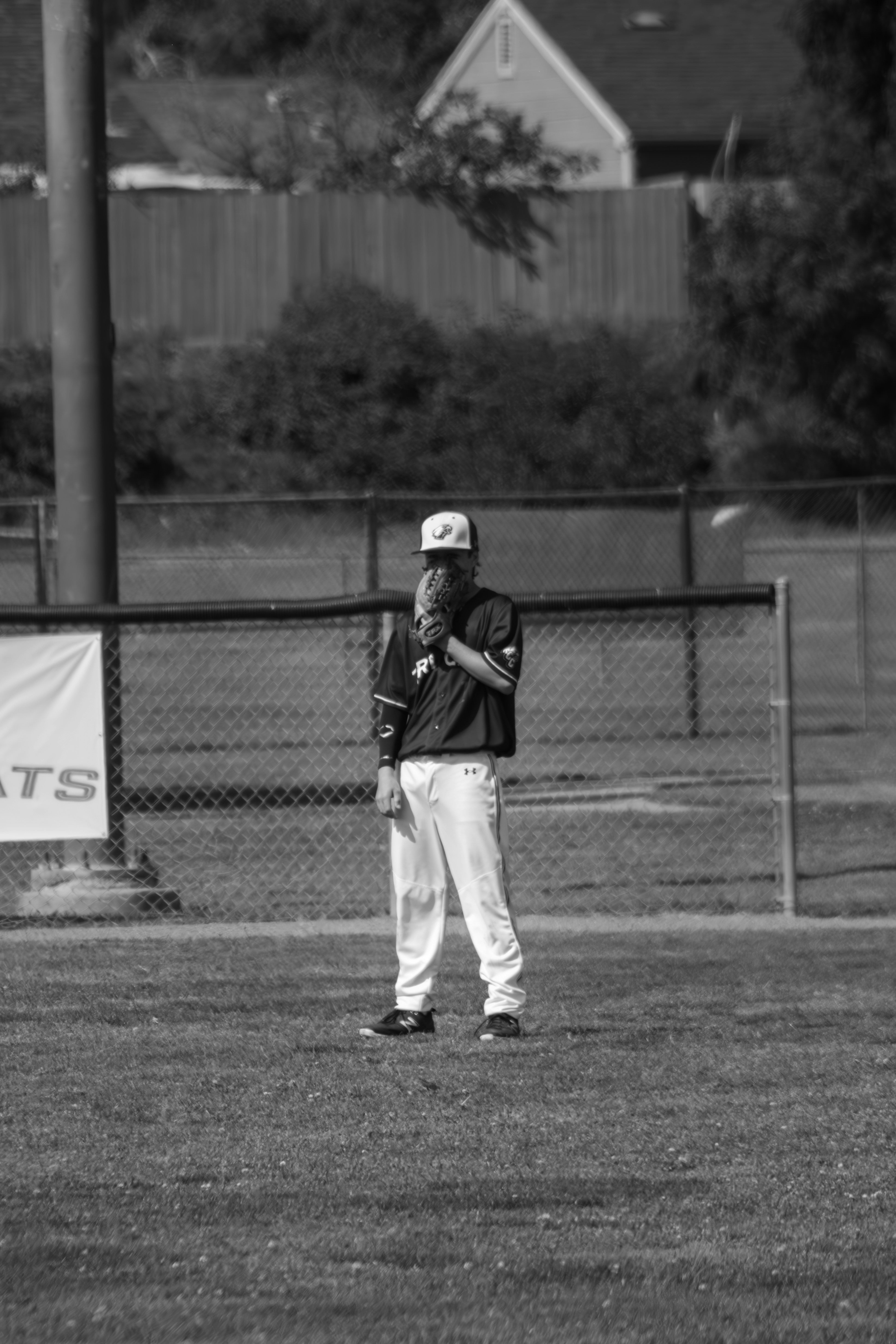 A baseball player stands on the field.