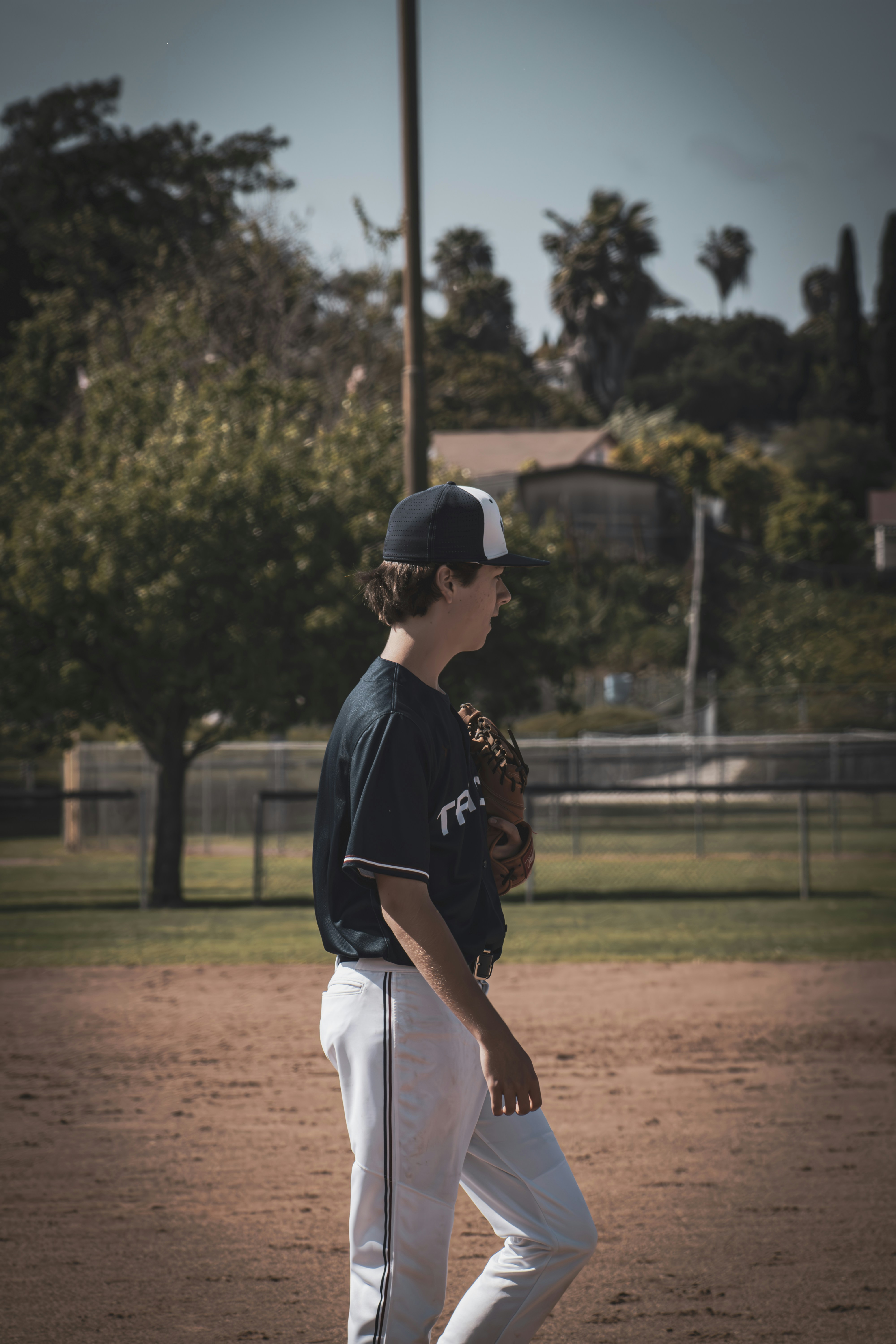 A baseball player stands on the field.