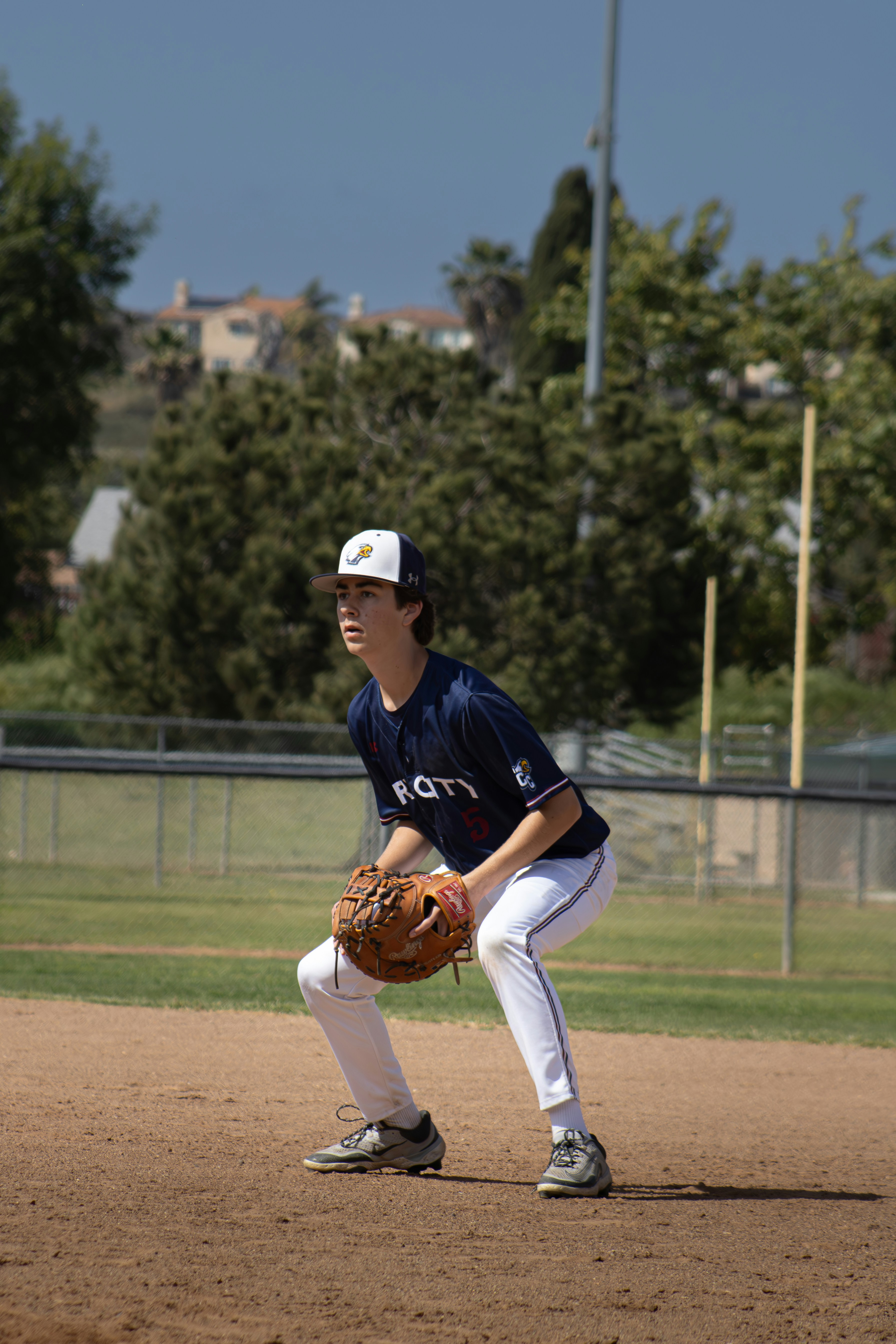 Baseball player fielding in the field.