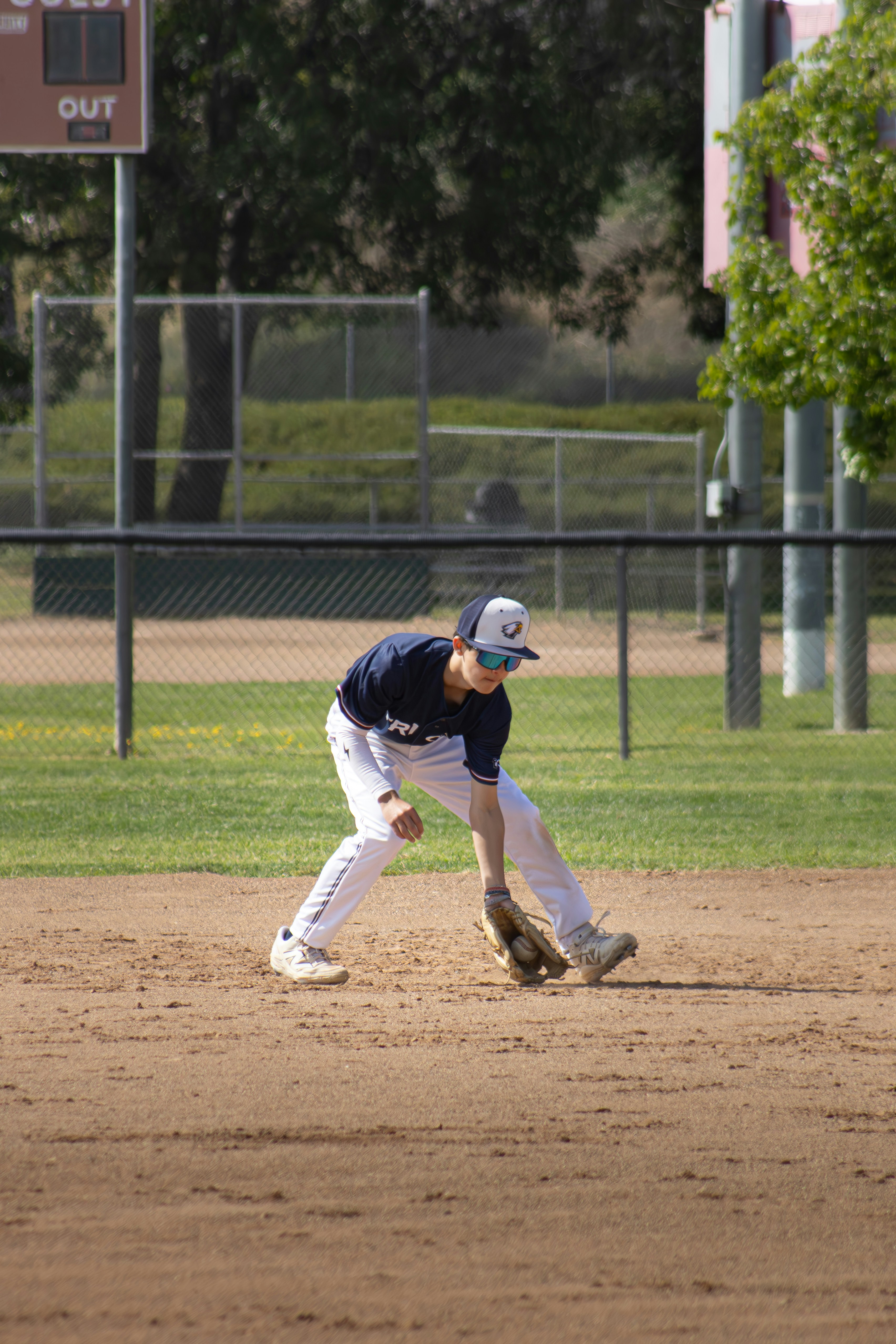 A baseball player is fielding the ball.
