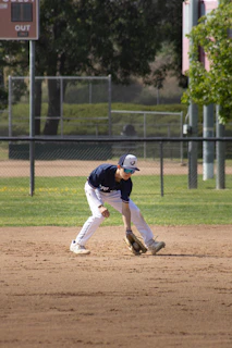 A baseball player is fielding the ball.