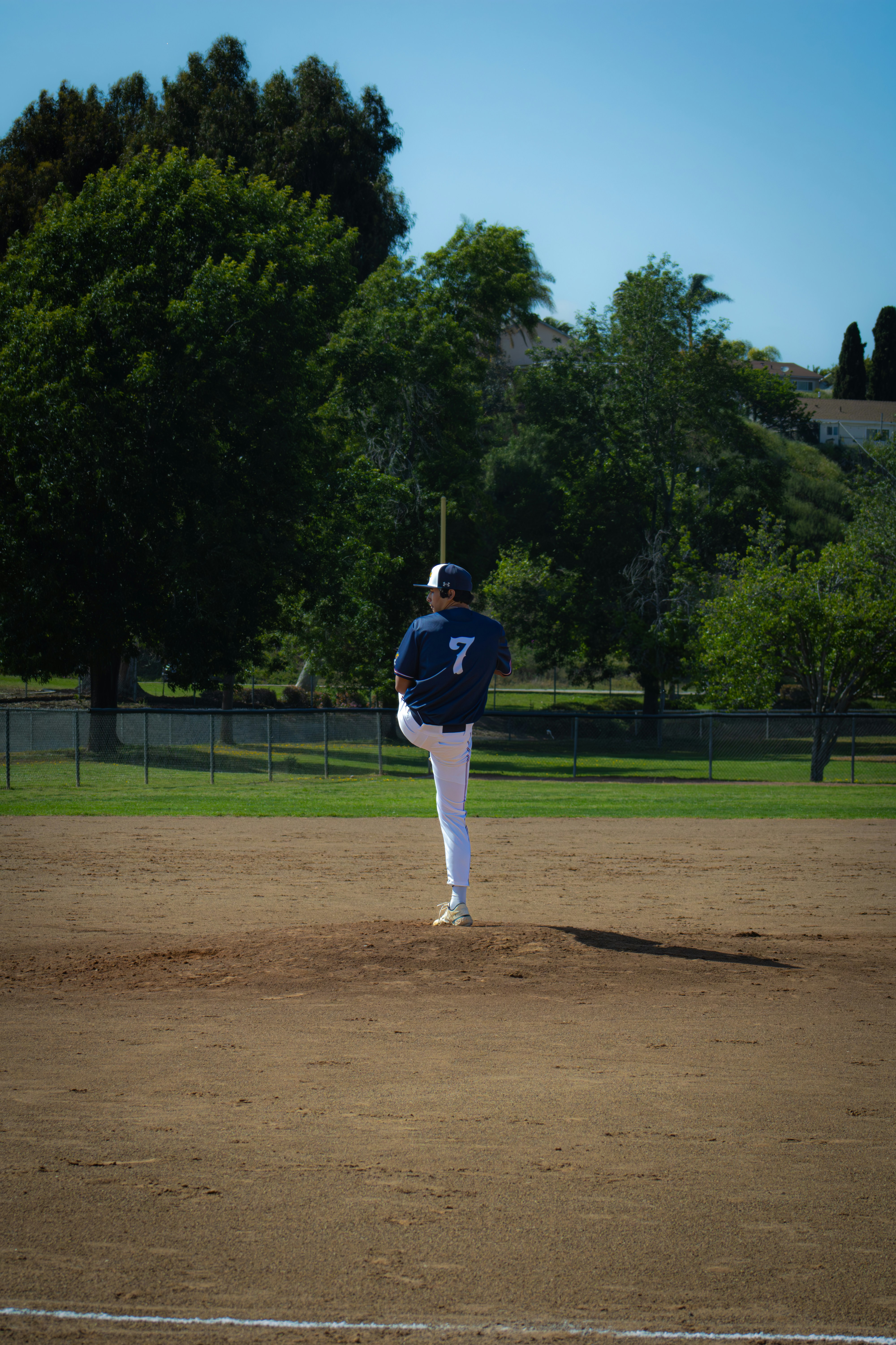 A baseball player is pitching on the field.