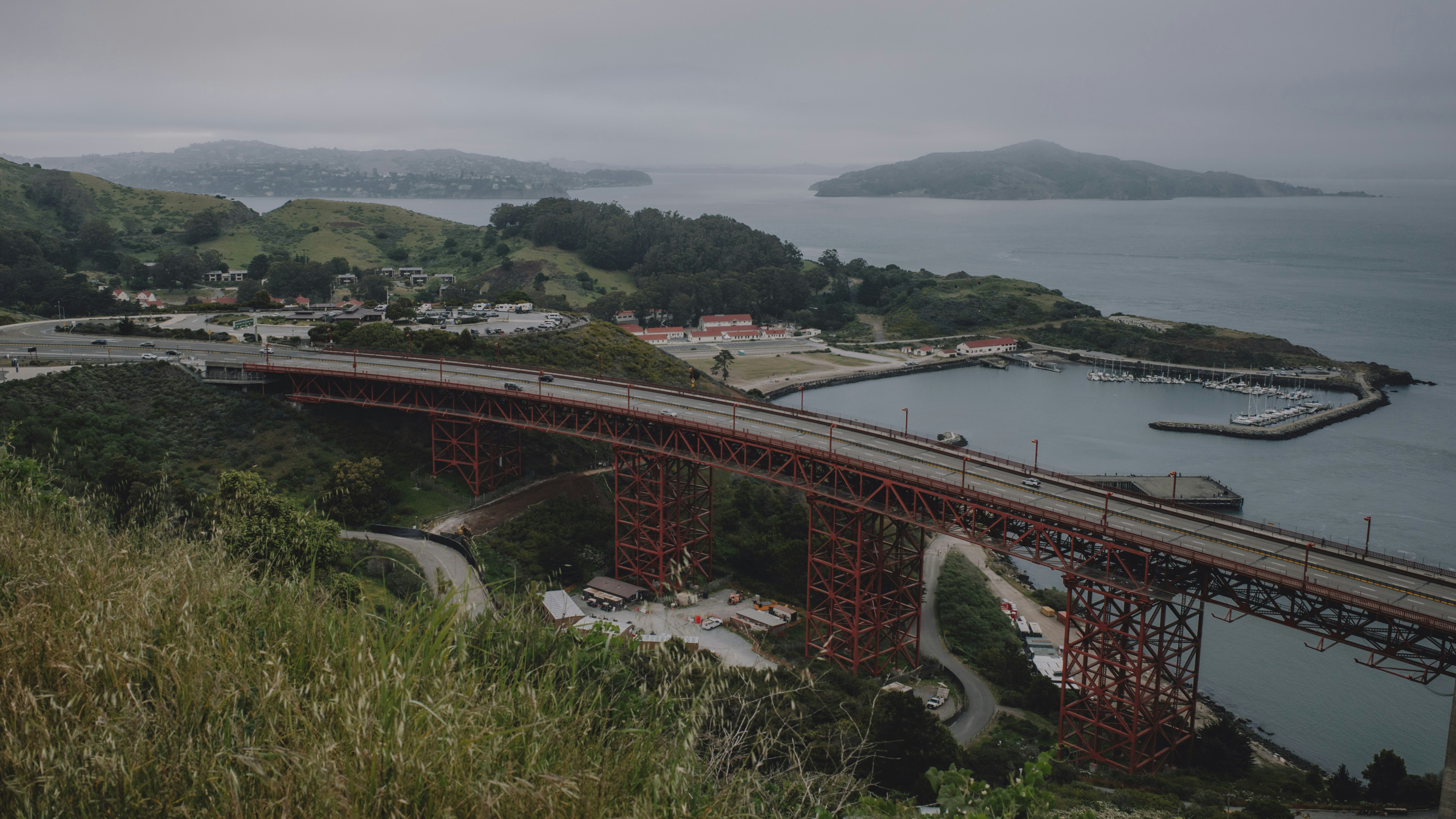 A bridge stretches over the water near a coastline.