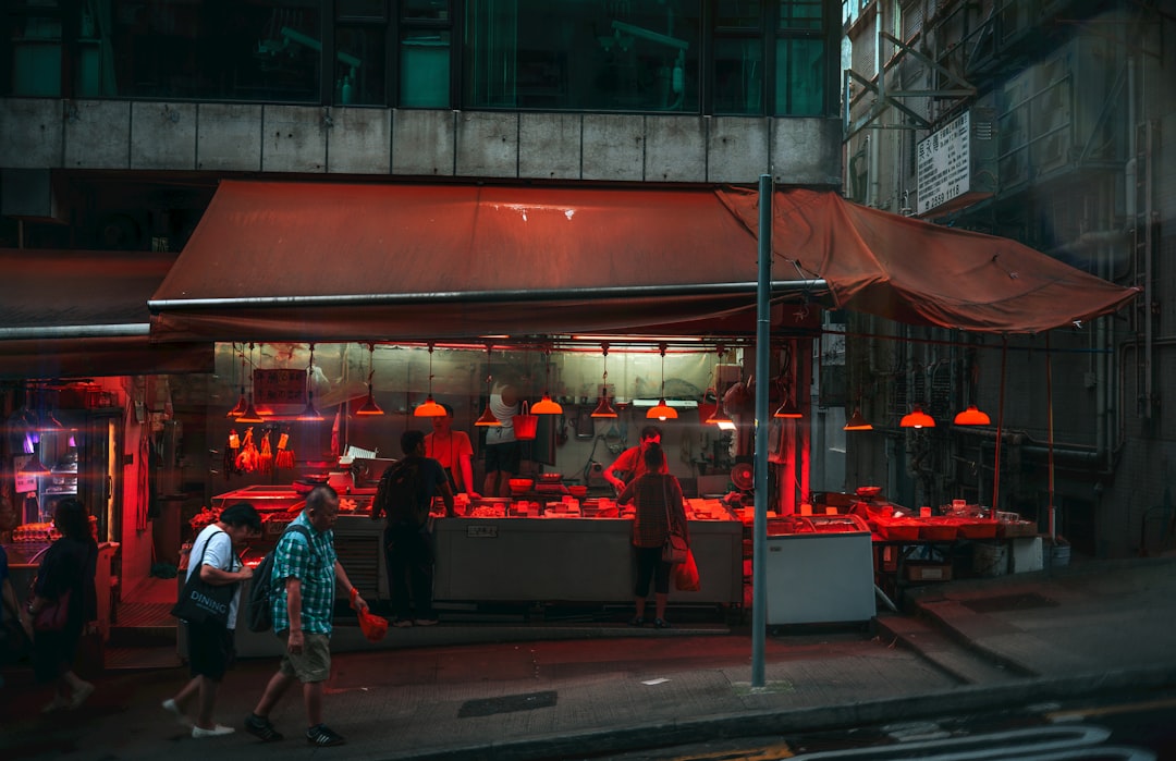 A butcher shop is illuminated with red lights.,