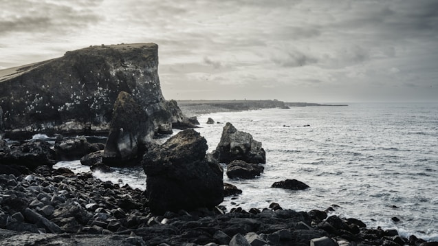 Rocky coastline under a moody, overcast sky.