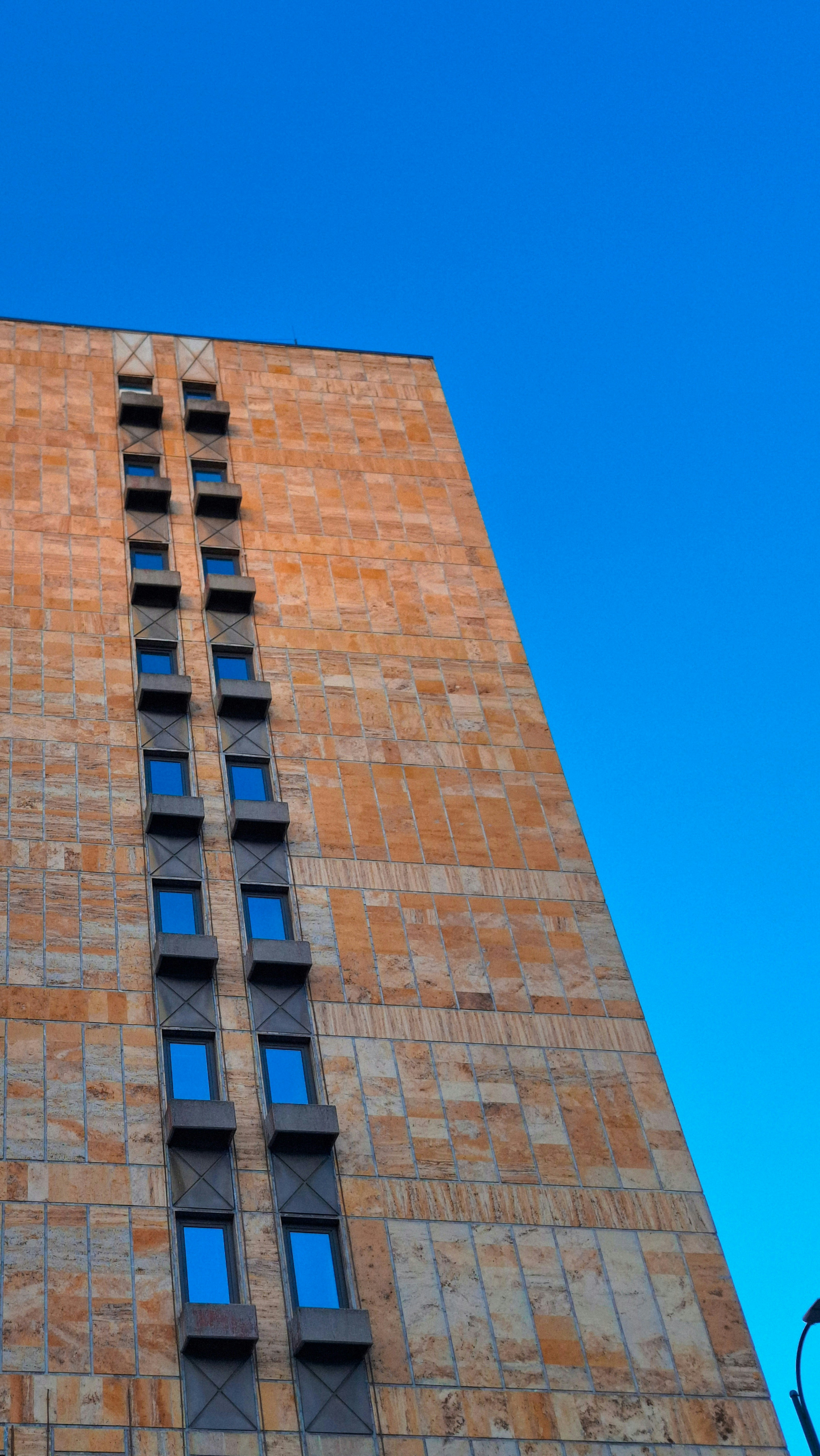 A tall building with several vertical windows.