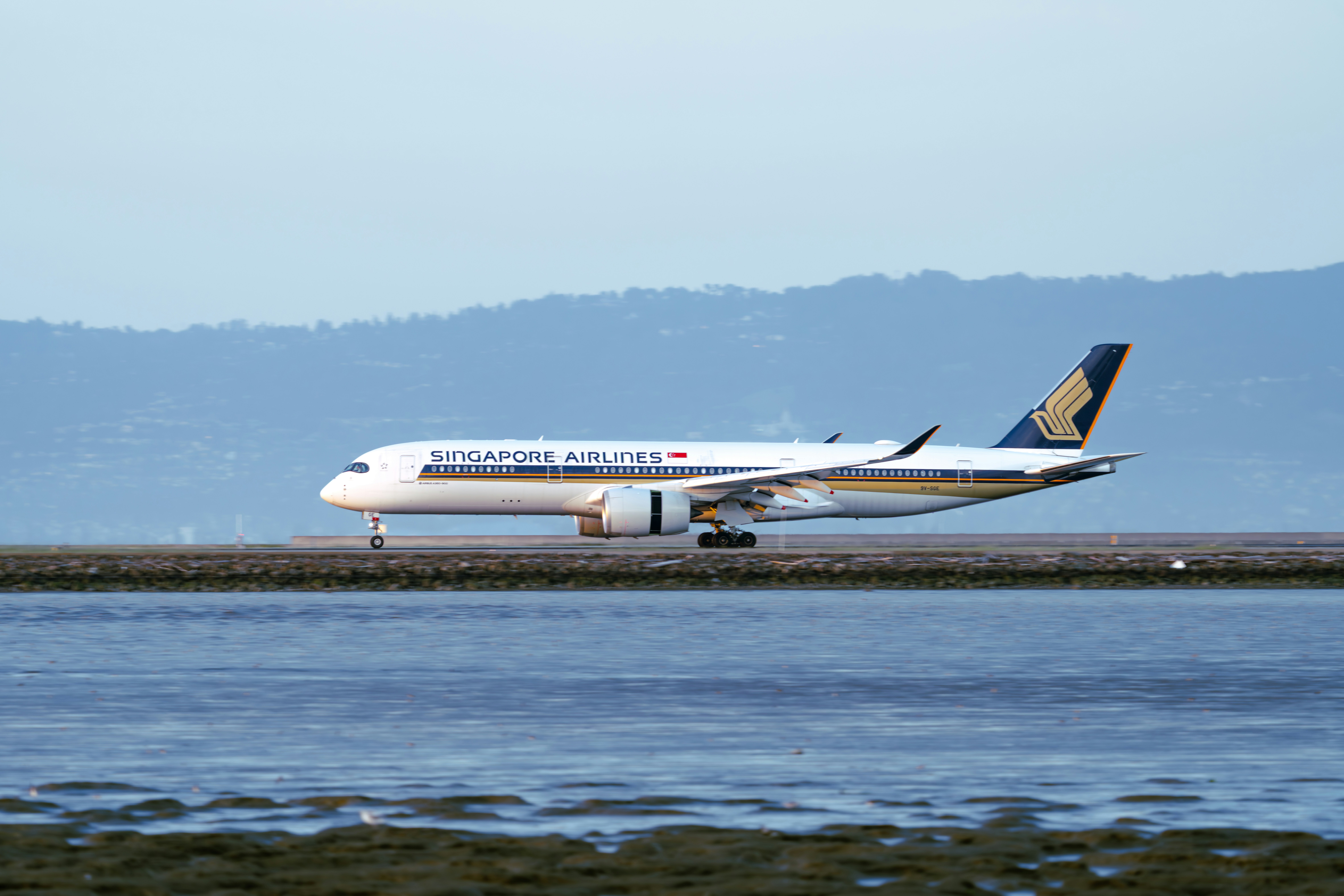 A singapore airlines plane is about to take off.