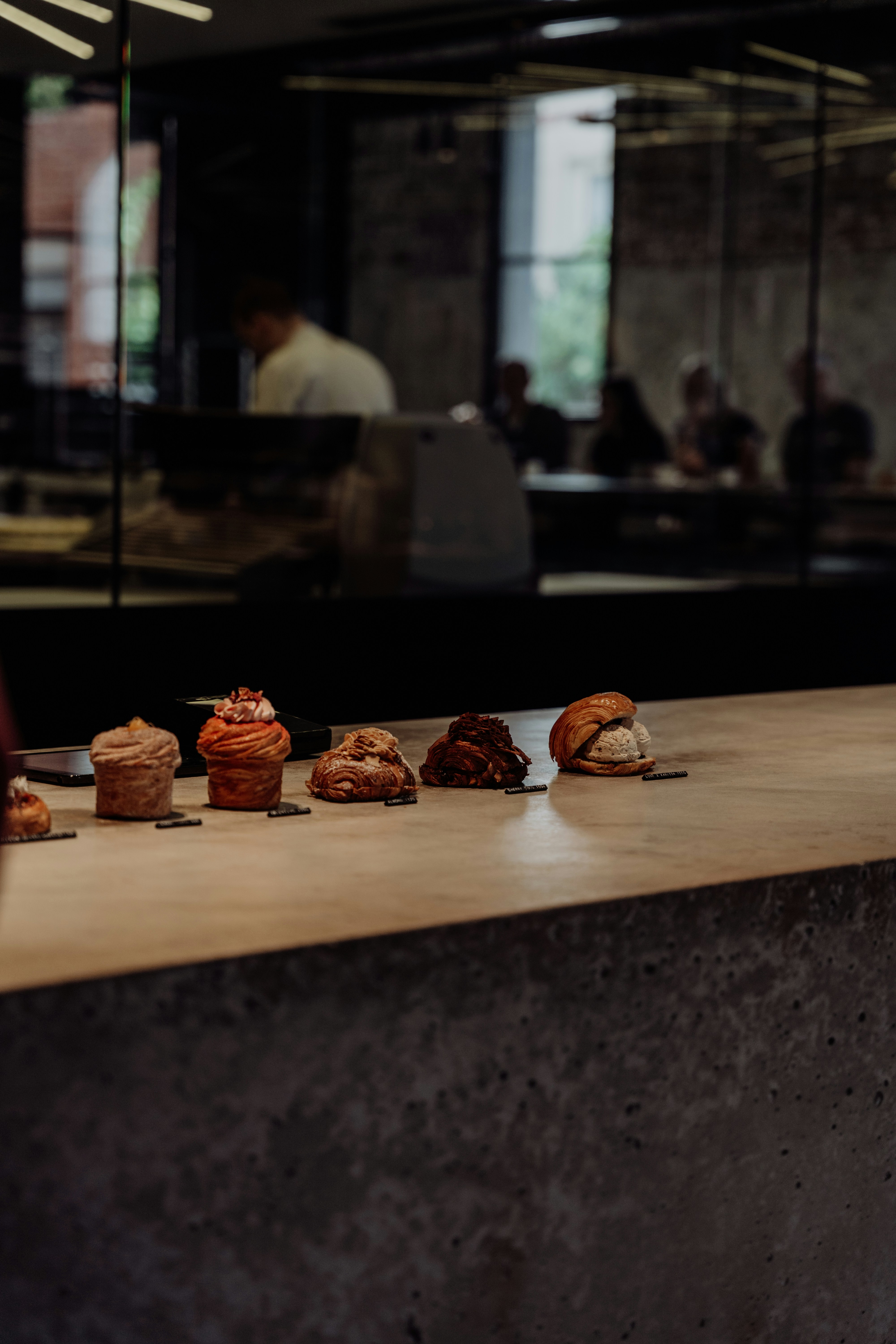 Pastries sit on a counter in a bakery.
