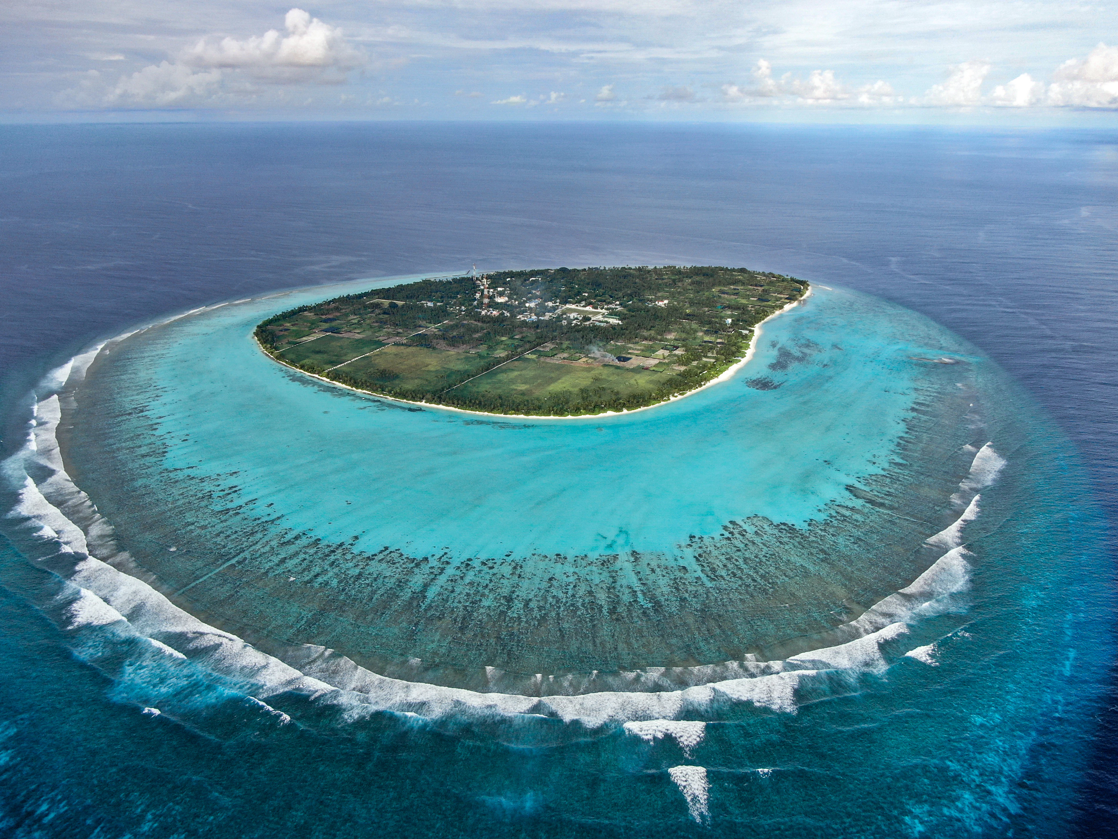 Aerial view of a coral reef in a turquoise lagoon