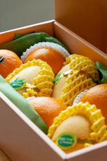 A box of oranges and mangoes.