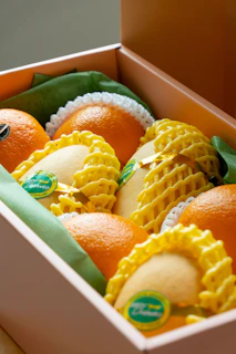 A box of oranges and mangoes.