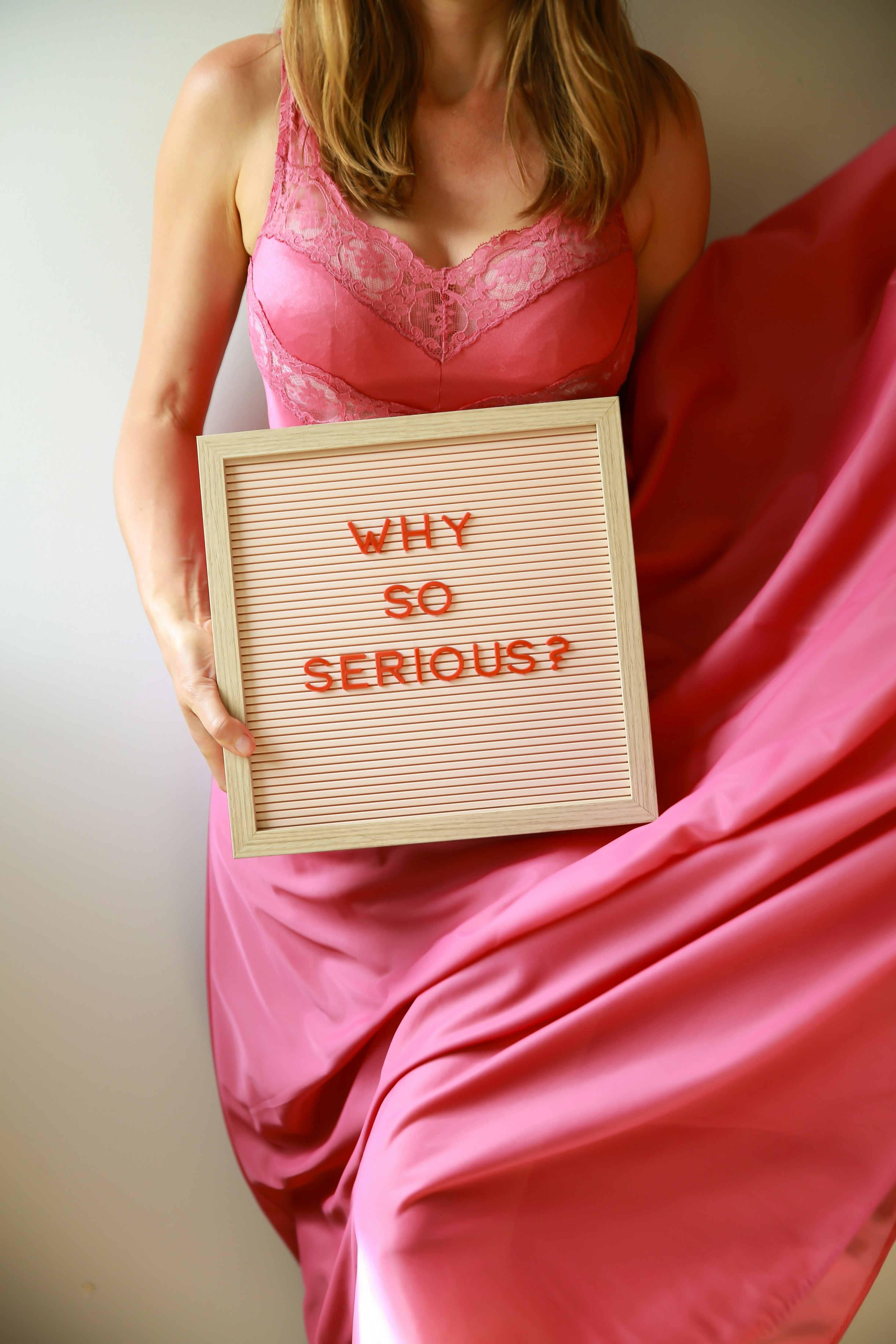 Woman looking thoughtful, hand on chin, with a subtle calendar and moon phase overlay, symbolizing reflection on cyclical emotions.