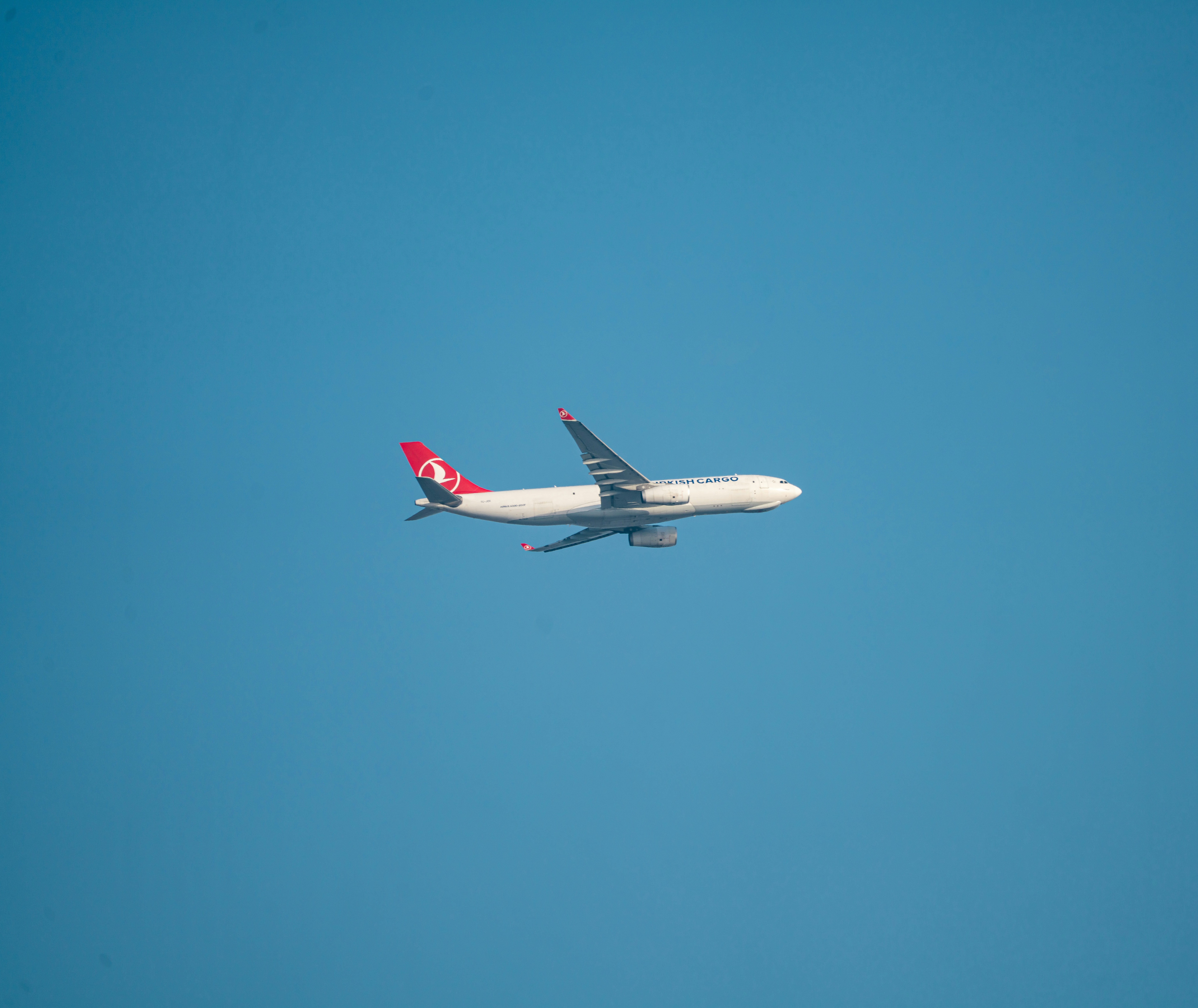 A plane flies high in the clear blue sky., Turkish Airlines Plane in Clear Blue Sky – Minimal Travel Concept A Turkish Airlines aircraft flying across a clear blue sky, symbolizing freedom, global travel, and aviation. Ideal for travel blogs, airline ads, flight booking platforms, and editorial use.
