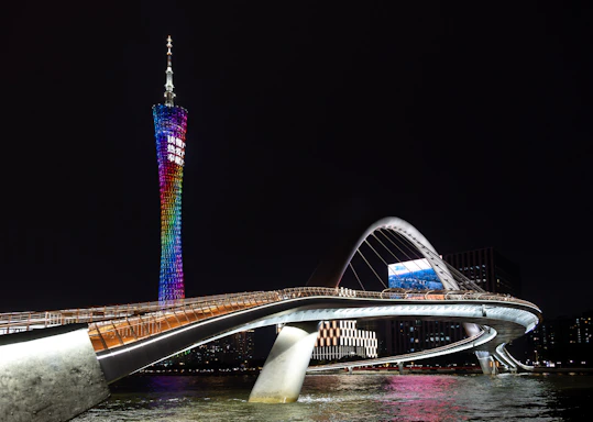 A bridge and tower lit up at night.