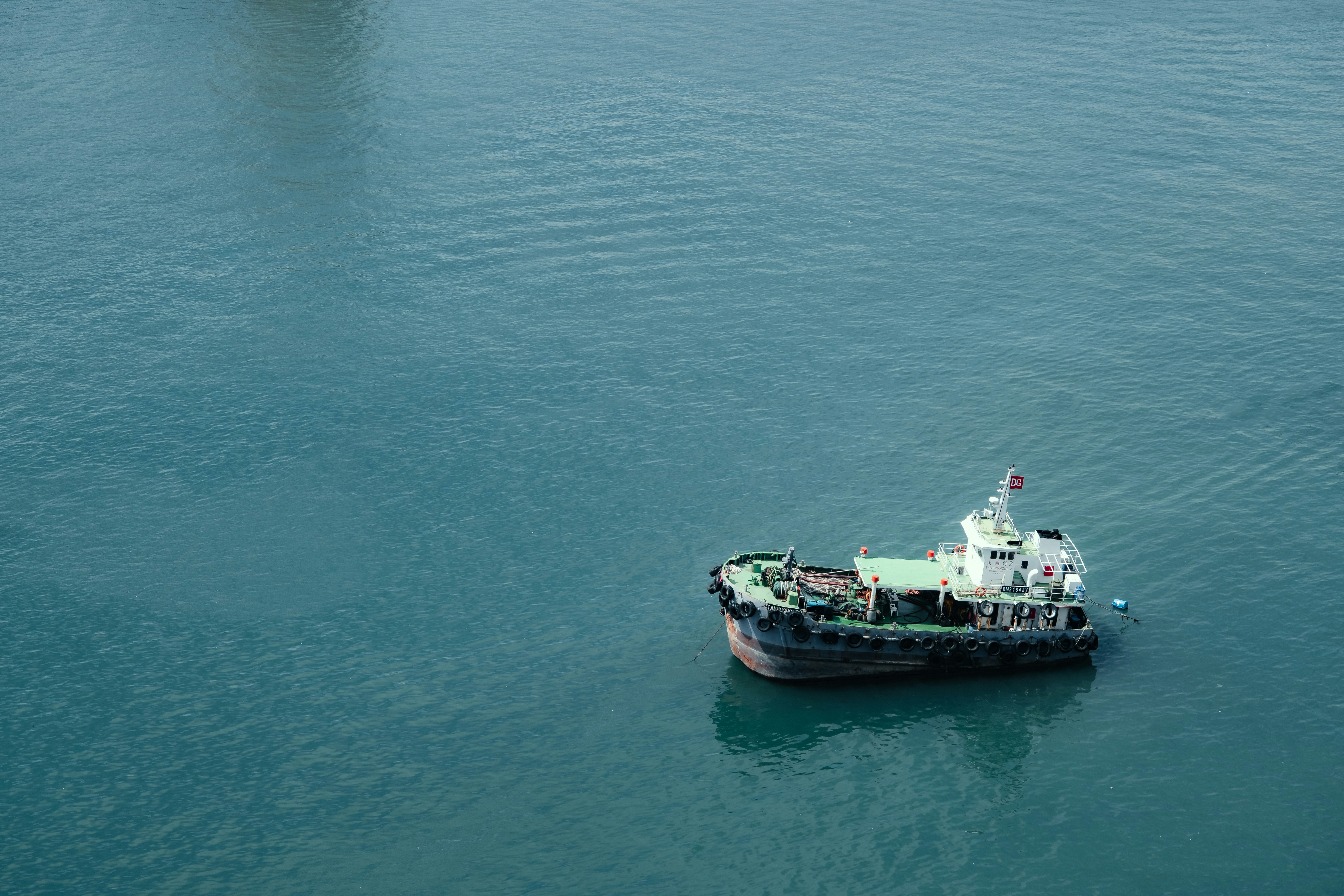 A small boat floats peacefully on the water.