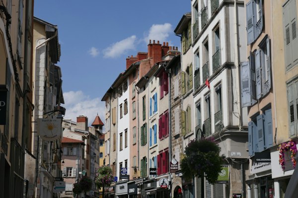 A street of tall painted houses — Le Puy-en-Velay, France