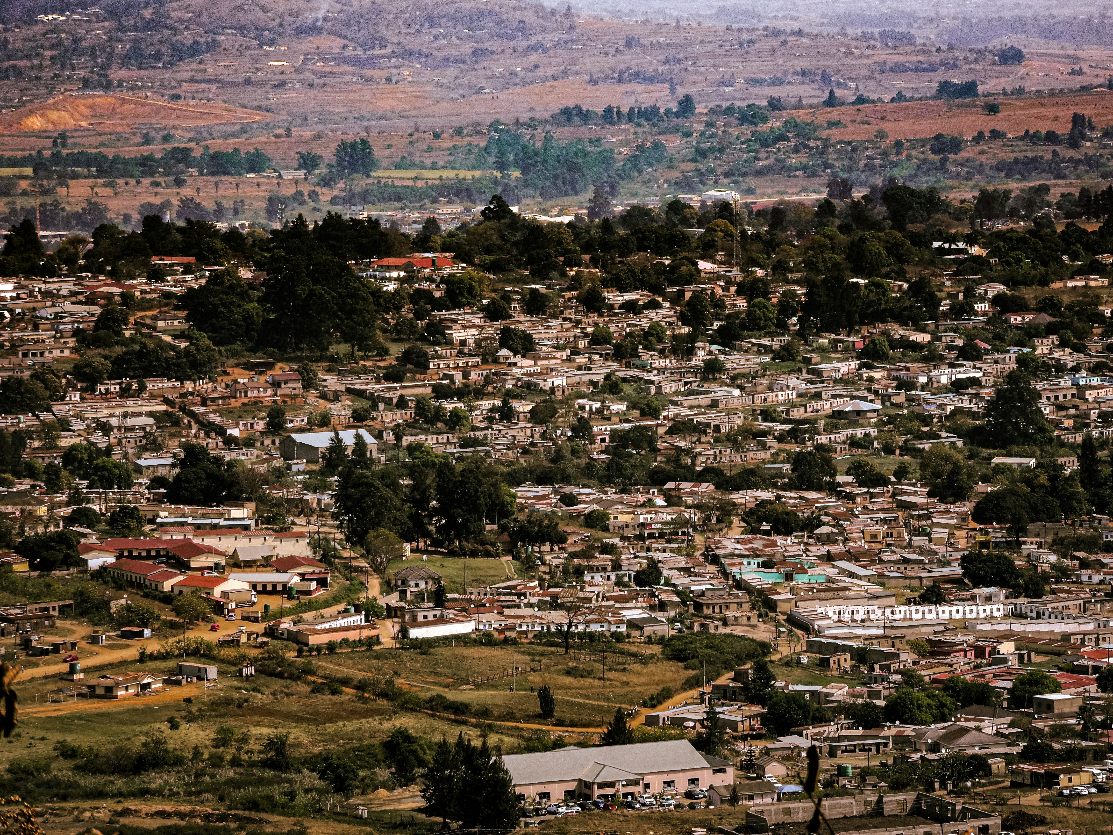 Dense urban settlement nestled in rolling hills.