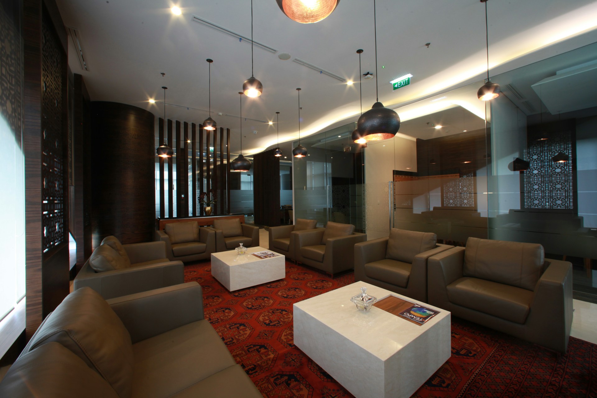 Lounge area with sofas and hanging lights.