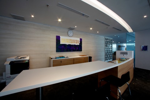 Modern office reception area with a long desk.