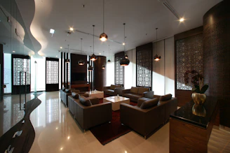 Modern lobby with seating, stylish lighting.