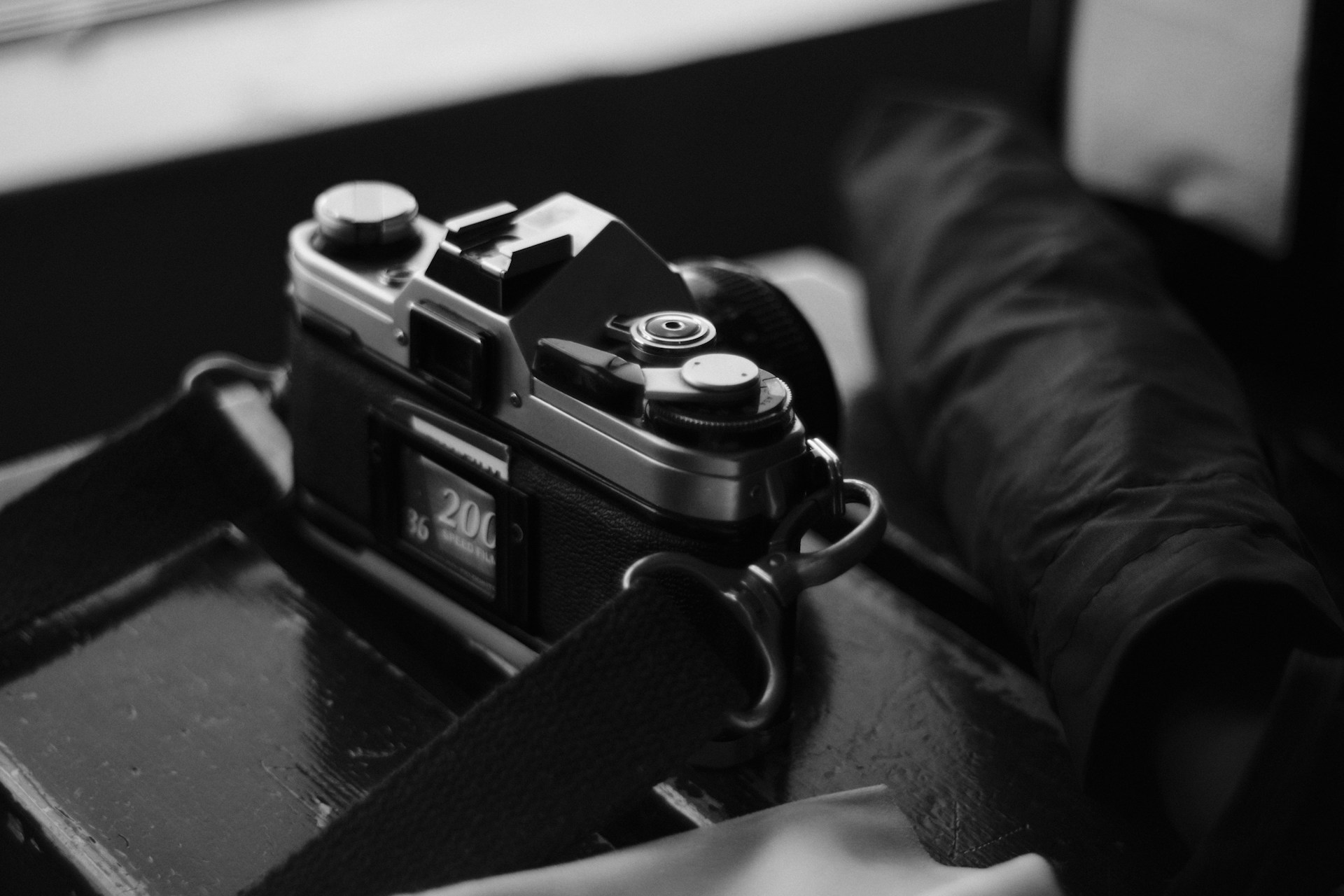 A vintage camera sits on a tabletop.