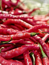 Pile of vibrant red chili peppers.
