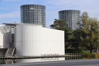 Modern architecture with cylindrical towers and white walls.