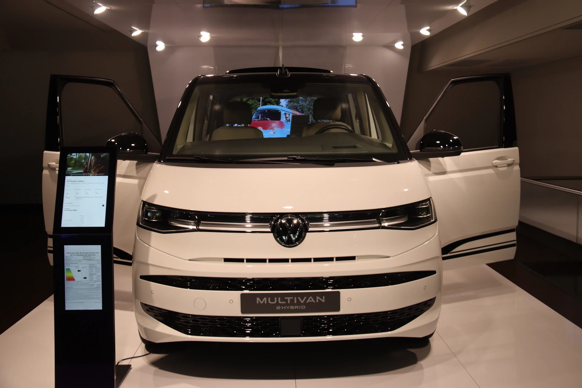 White Volkswagen Multivan on display; passenger-van example, not the exact rental model