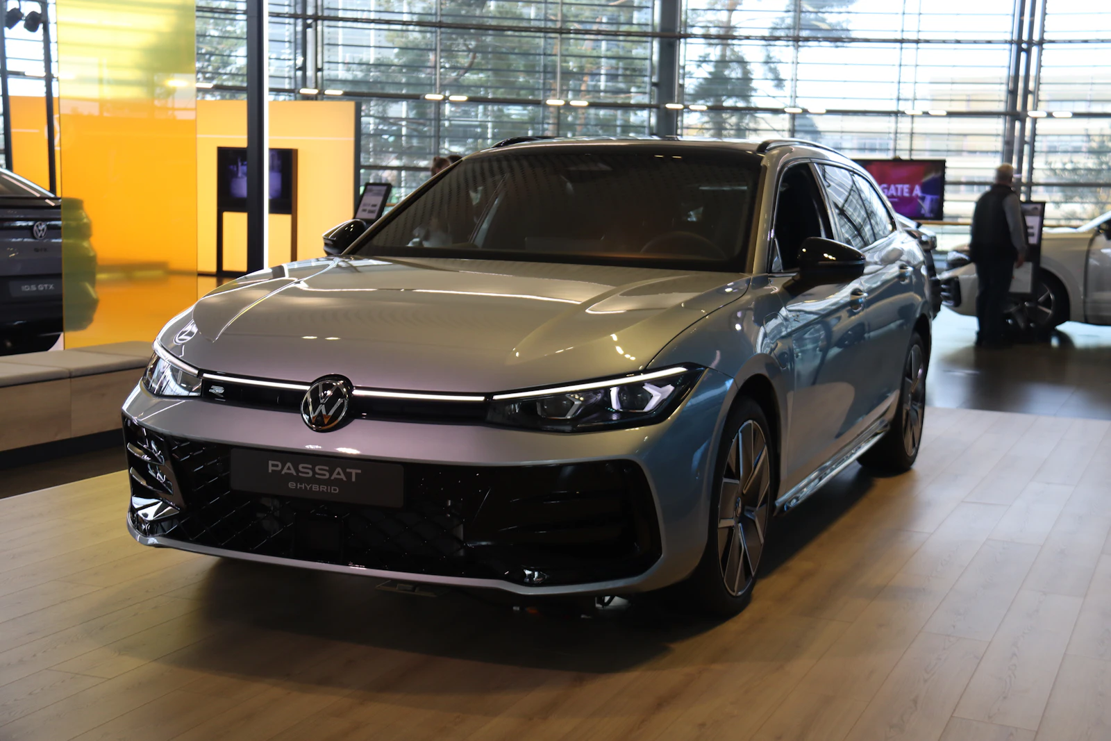 Silver Volkswagen Passat photographed from a front three-quarter angle on display