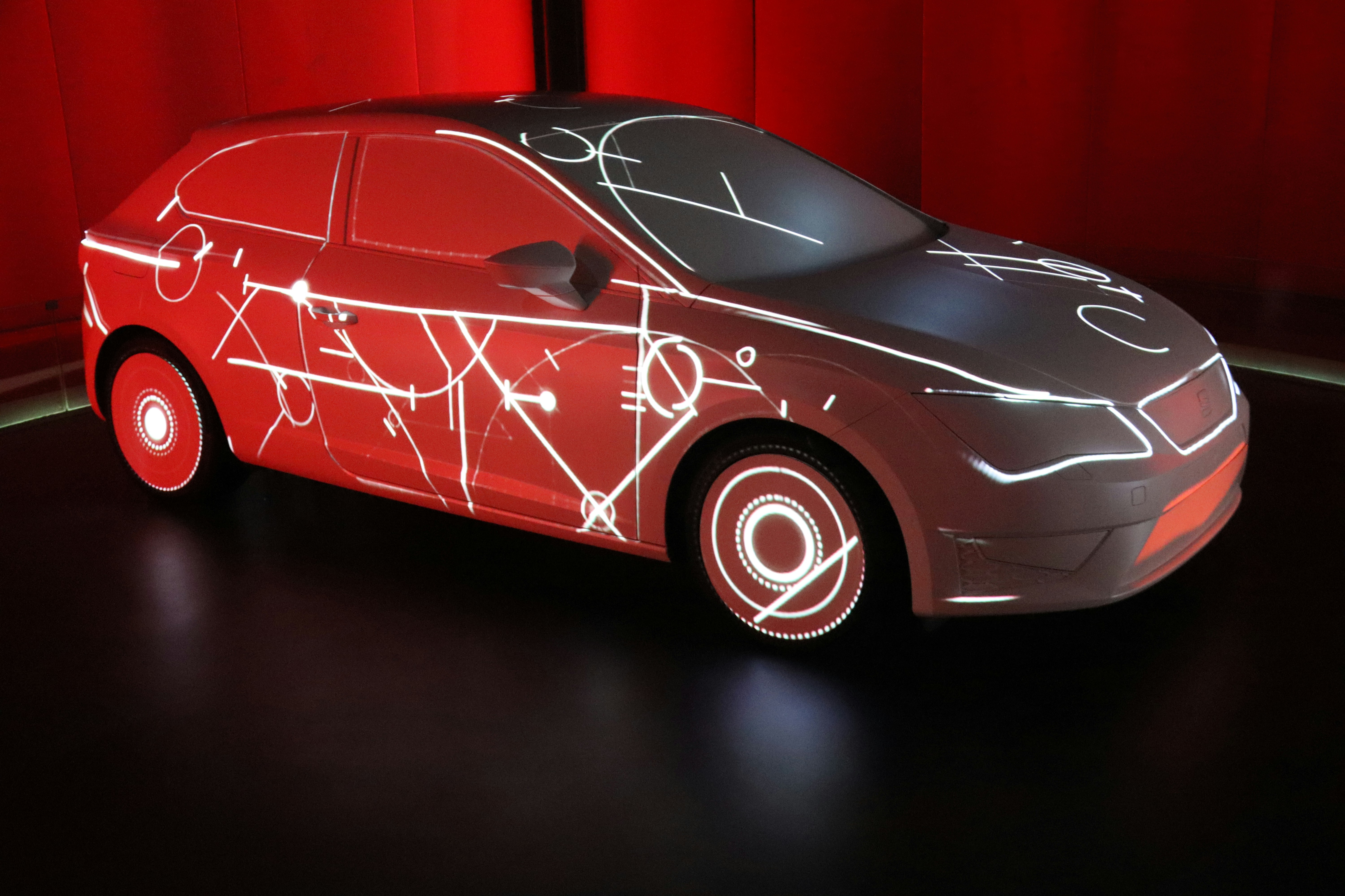 Futuristic low electric sedan concept car in a studio environment