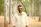 A man poses in a forest.