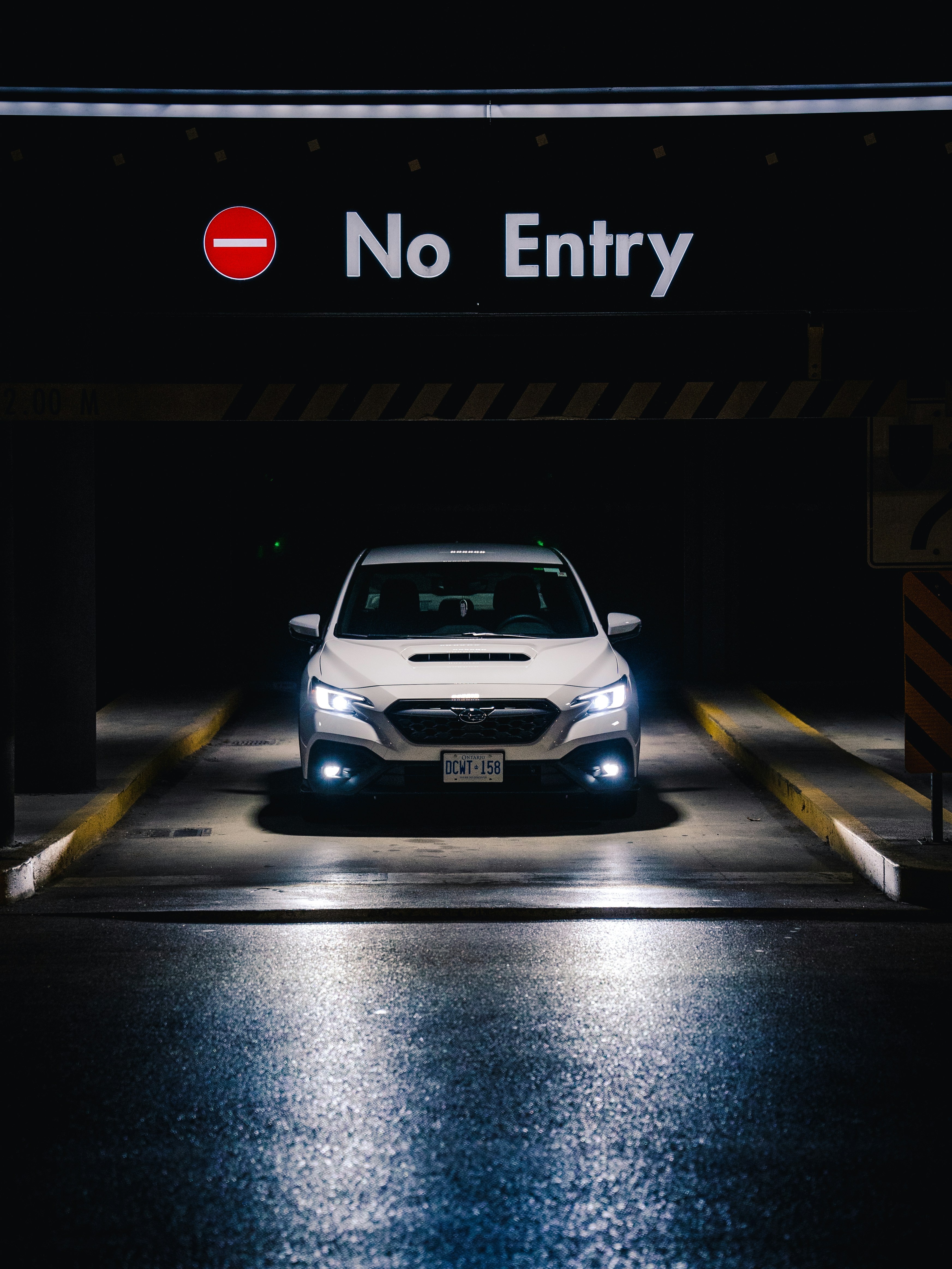 A white car attempts to enter a 