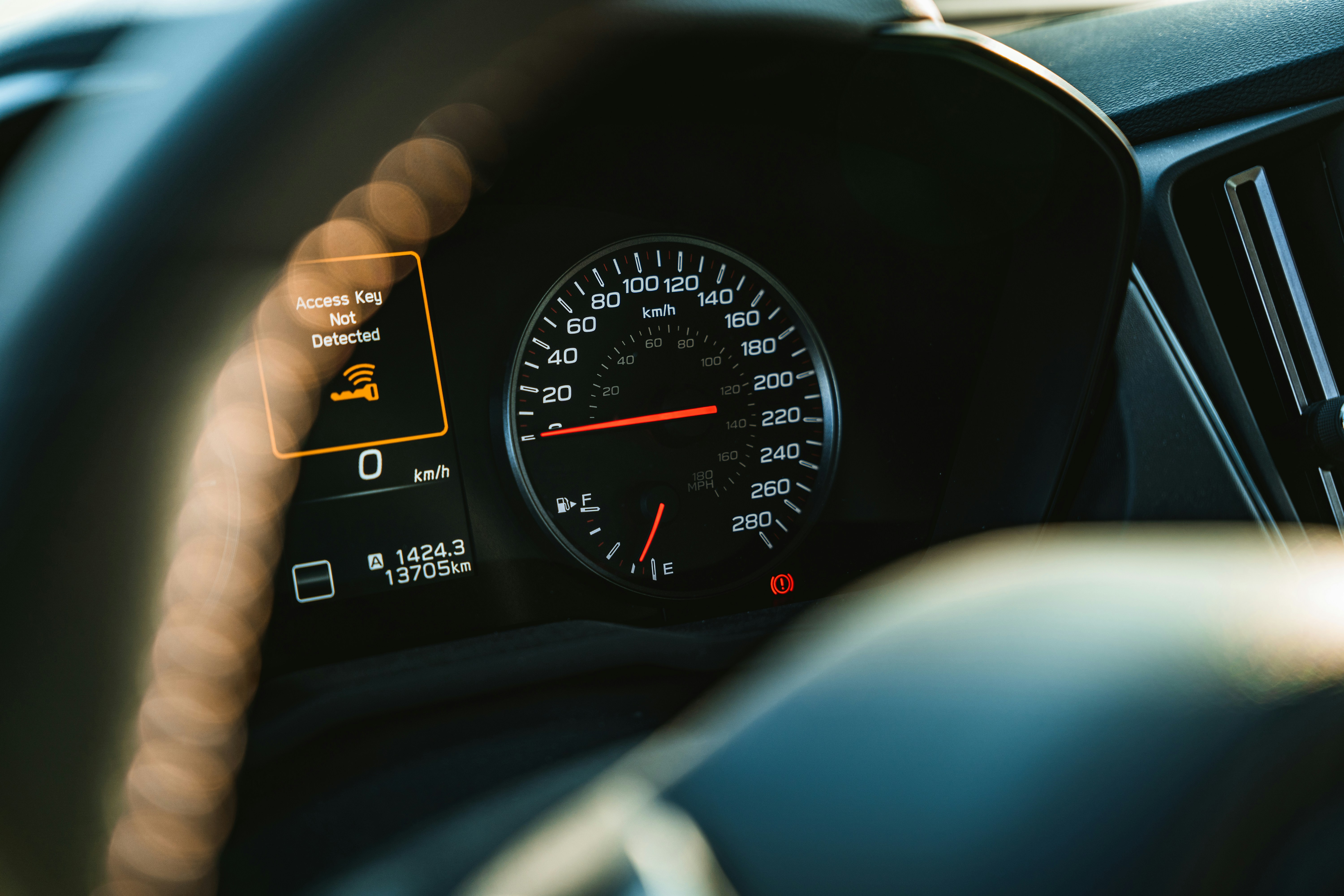A car's dashboard showing speed and gauges.