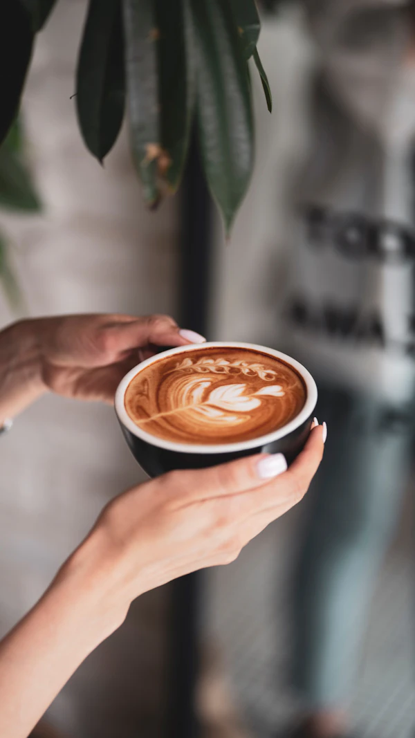 Manos sosteniendo un latte