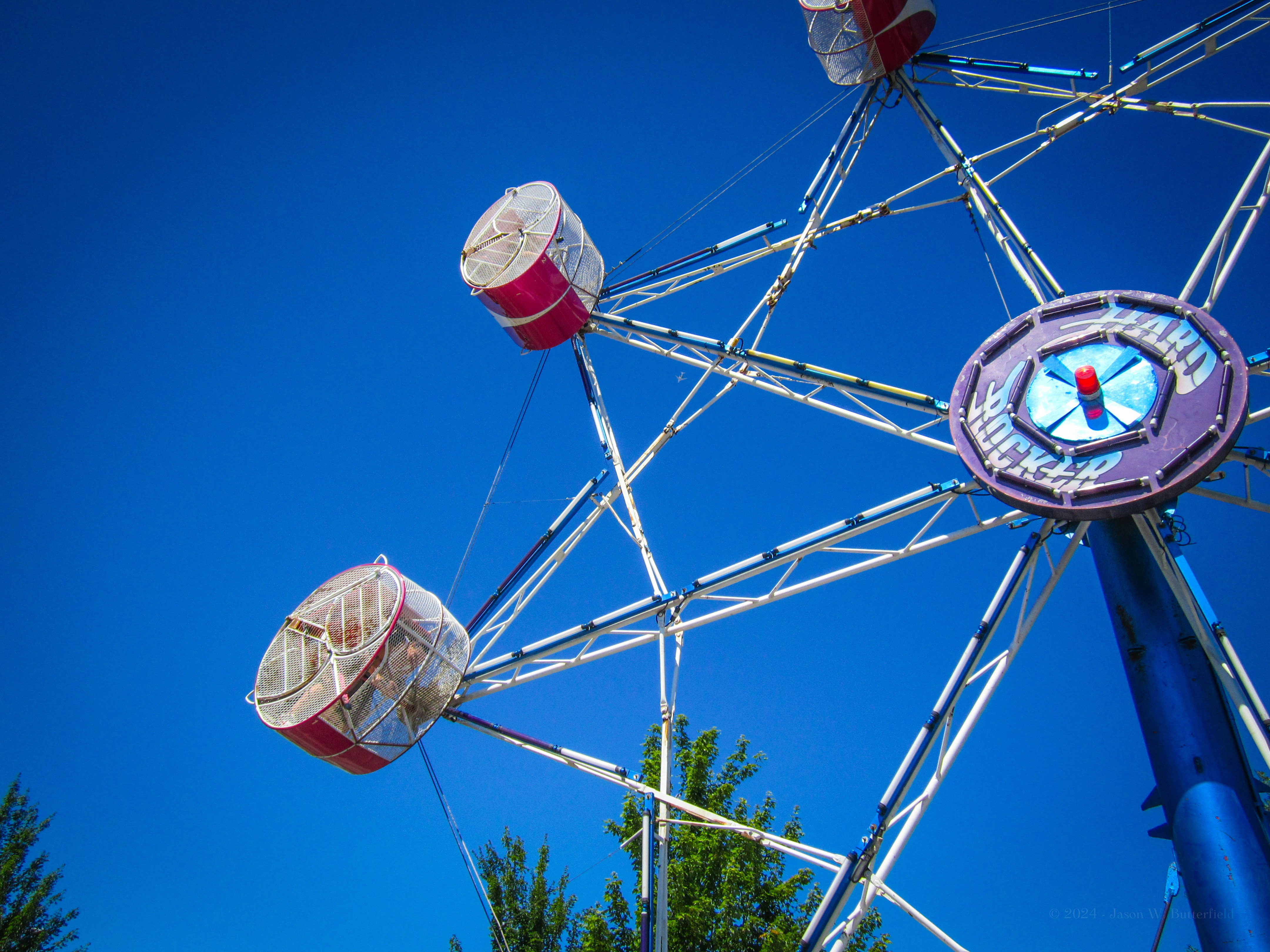 A ferris wheel against a clear blue sky.
