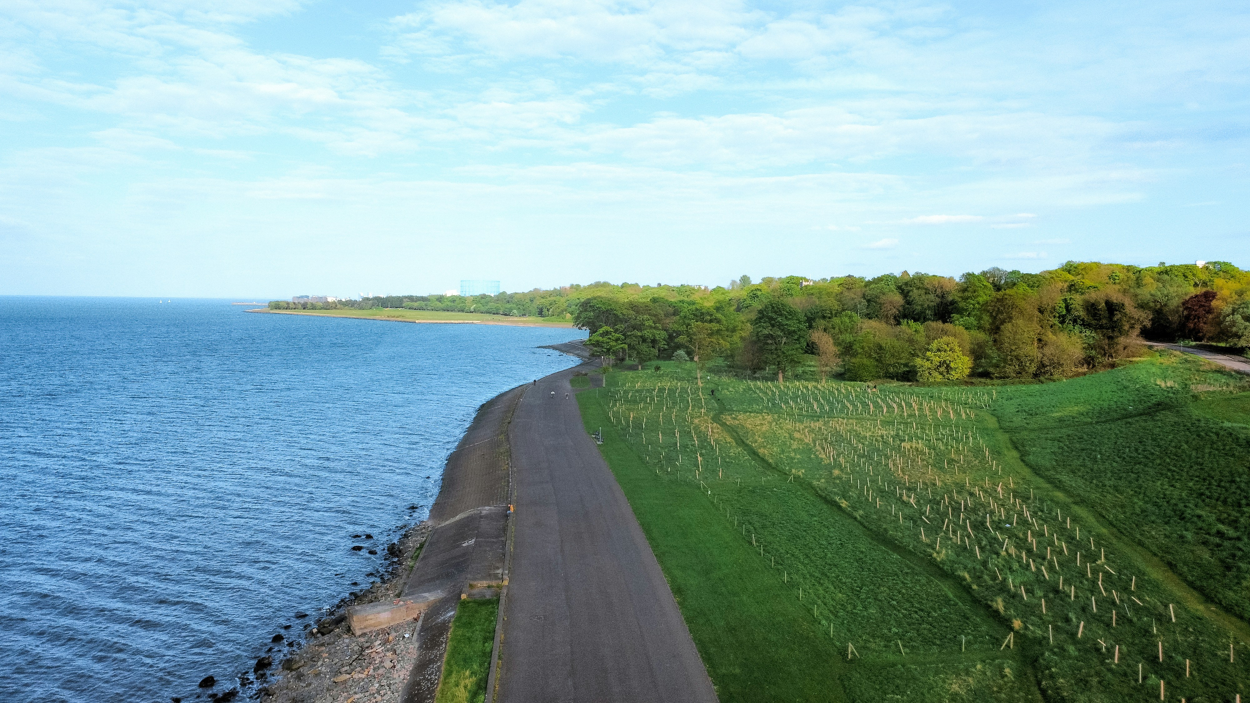 A coastal road runs alongside the ocean.