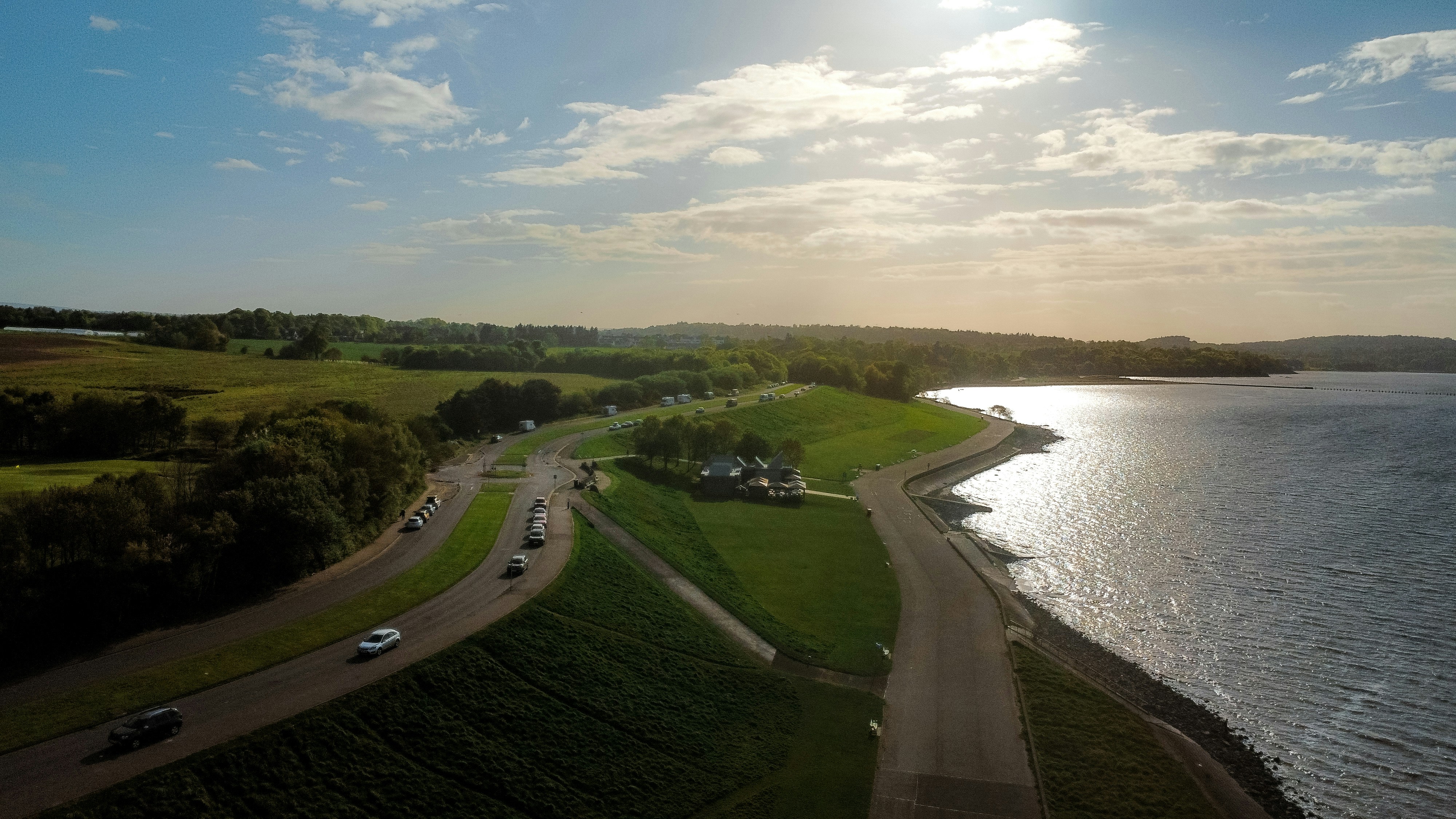 Aerial view of a road next to a lake.