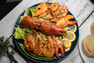 Lobster and shrimp are served on a plate.