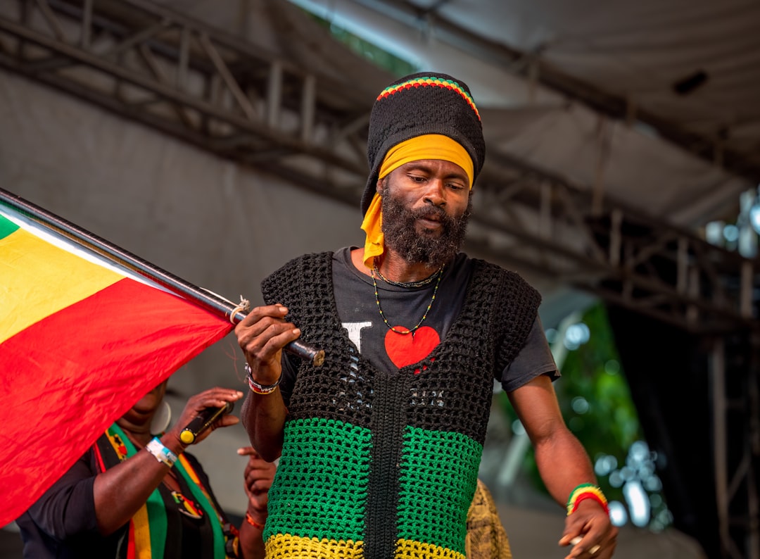 A rastafarian musician holds a flag on stage., Antigua and Barbuda