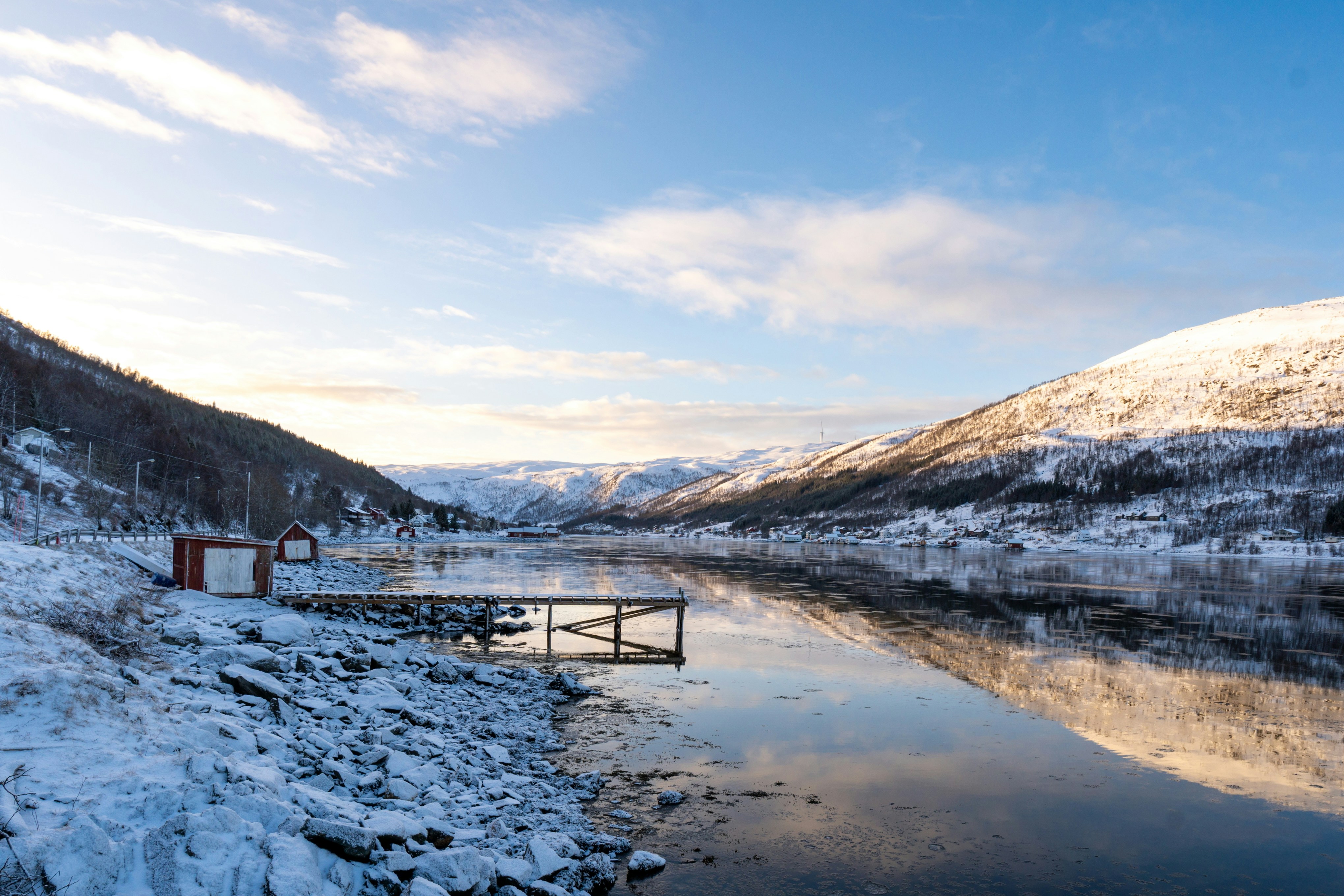 Snowy mountains reflected in a calm lake.