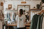 A woman looks at clothes in a stylish boutique.