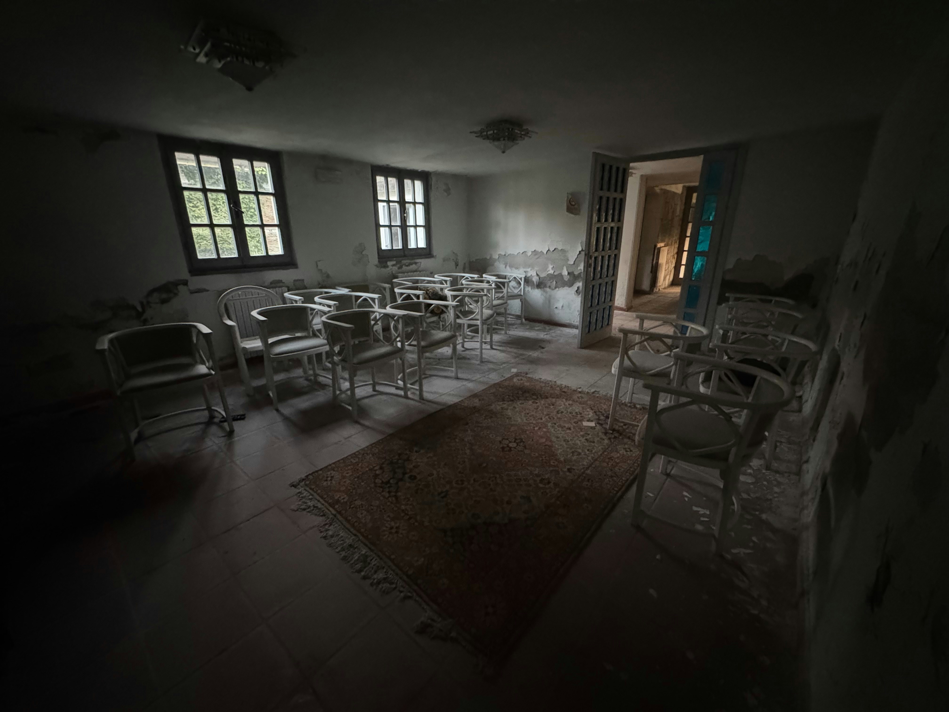 Empty hospital corridor with flickering lights creating an eerie atmosphere