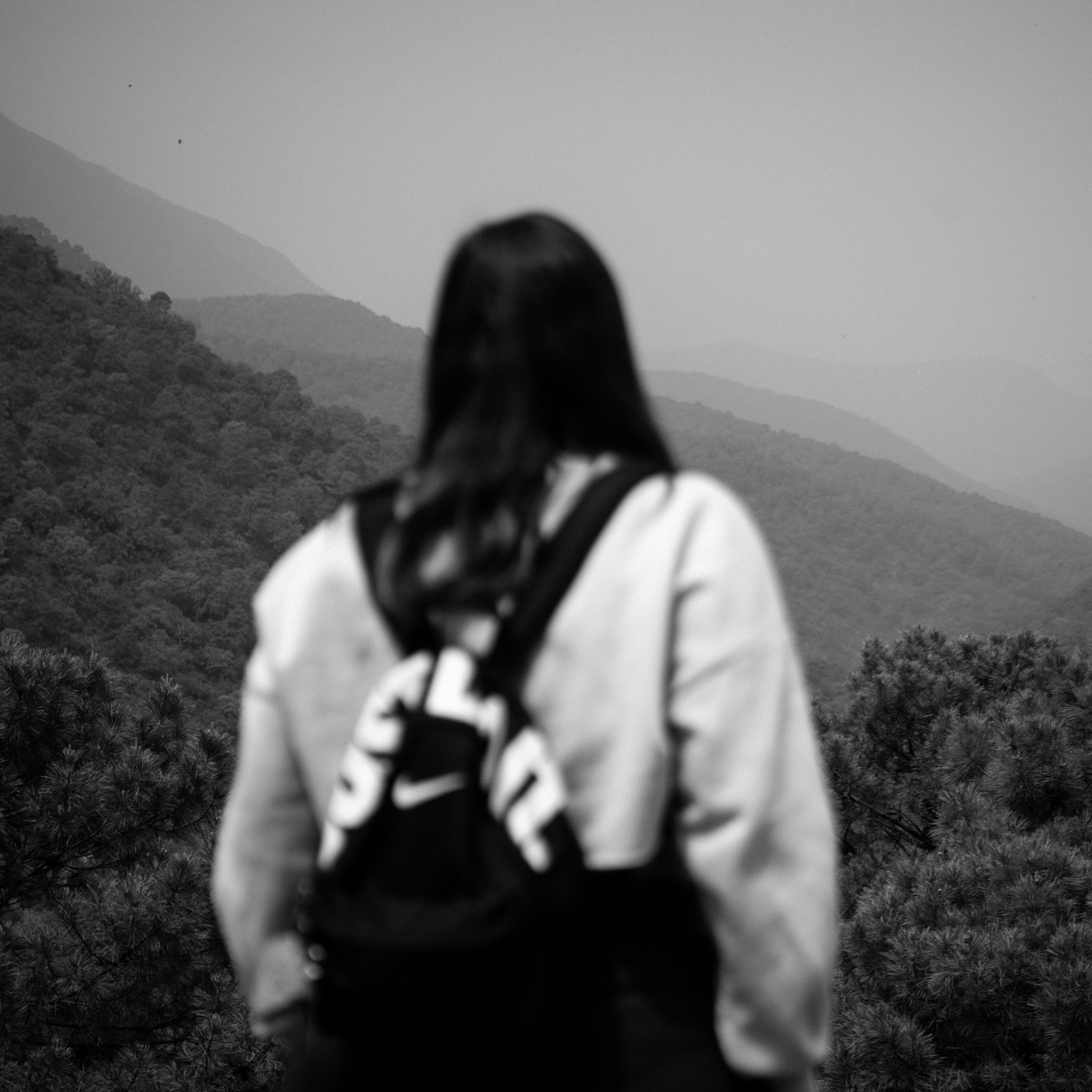 A woman hikes and views the majestic mountains.