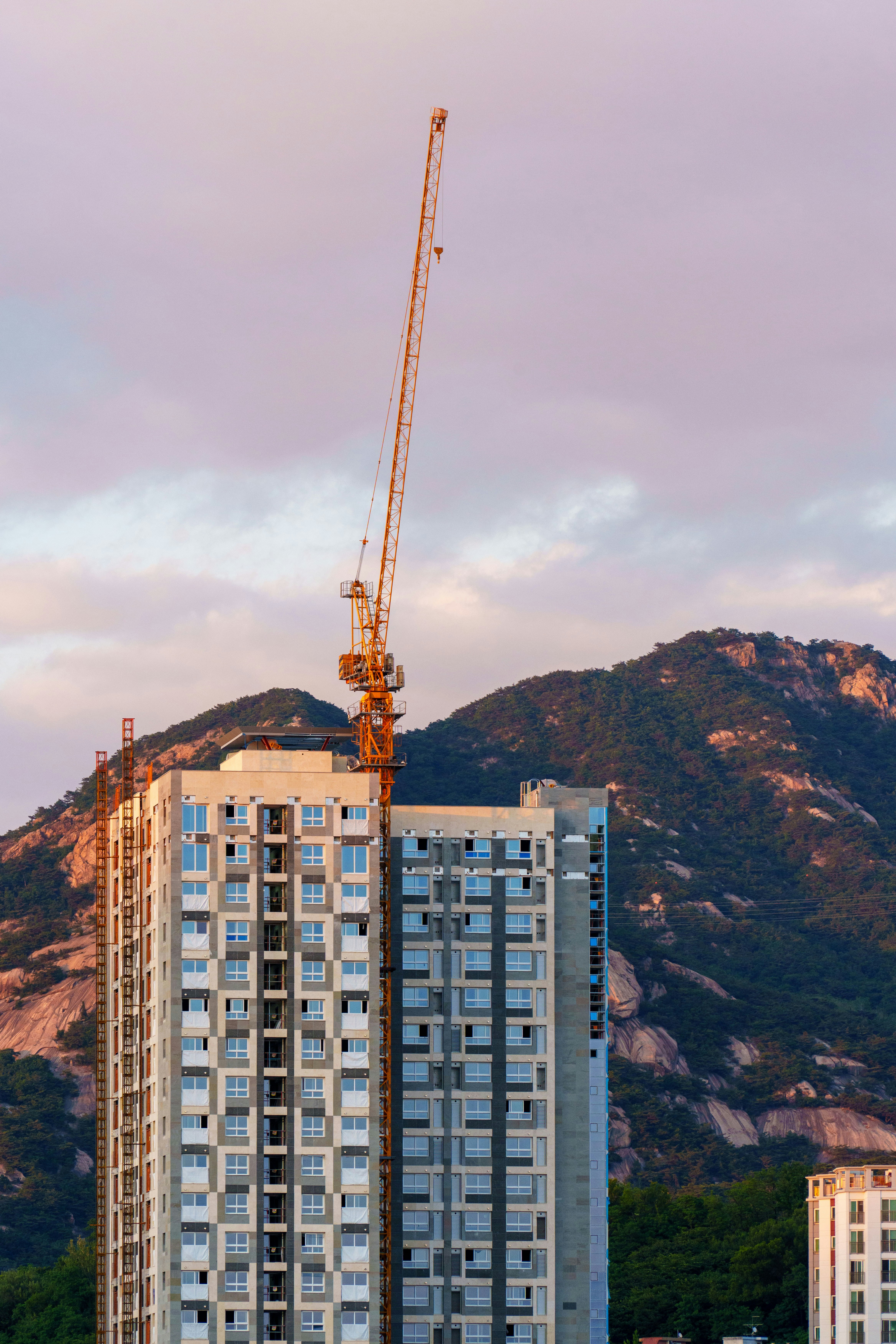 Construction crane atop a high-rise building. photo – Free Building ...