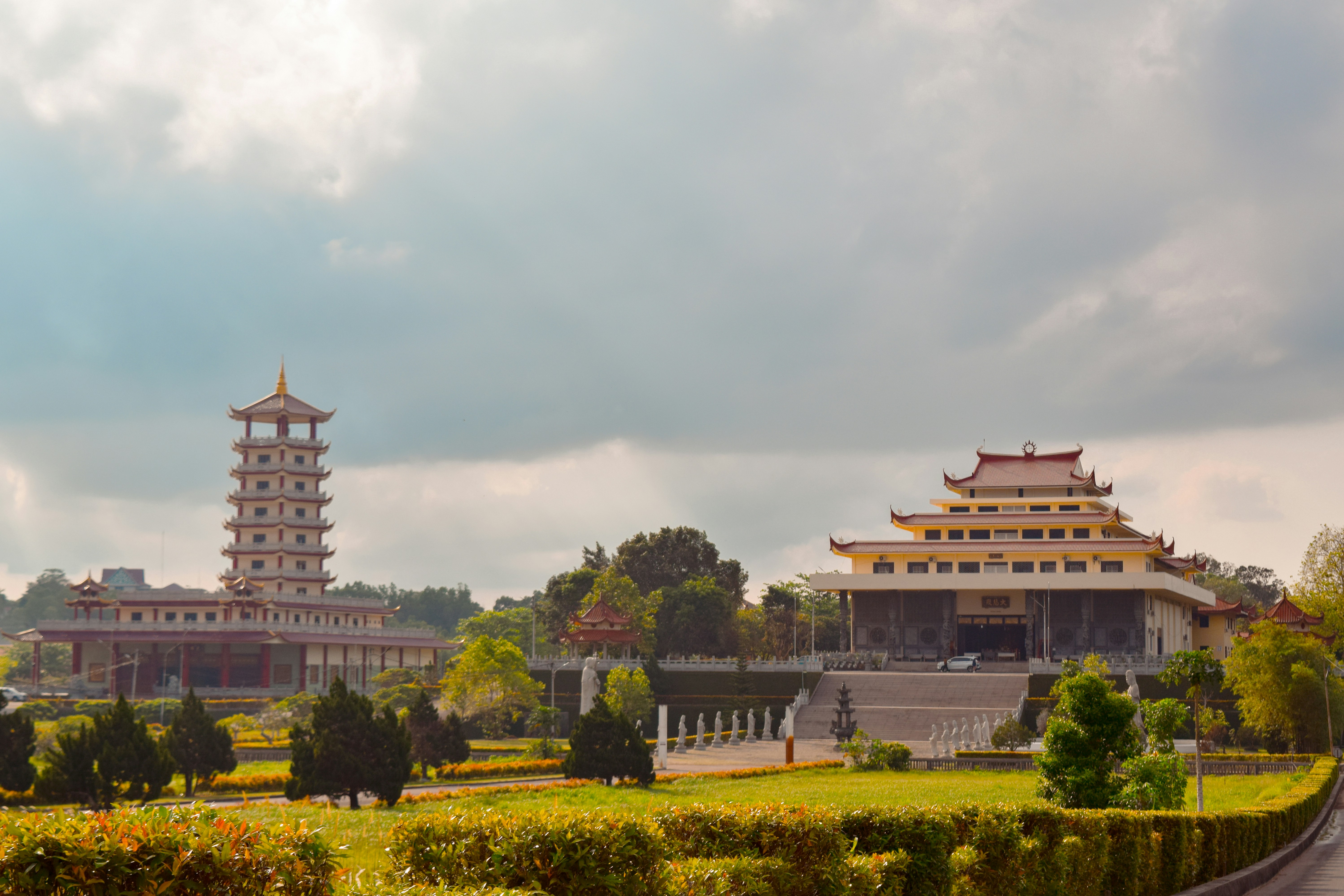 A beautiful asian temple against a cloudy sky.