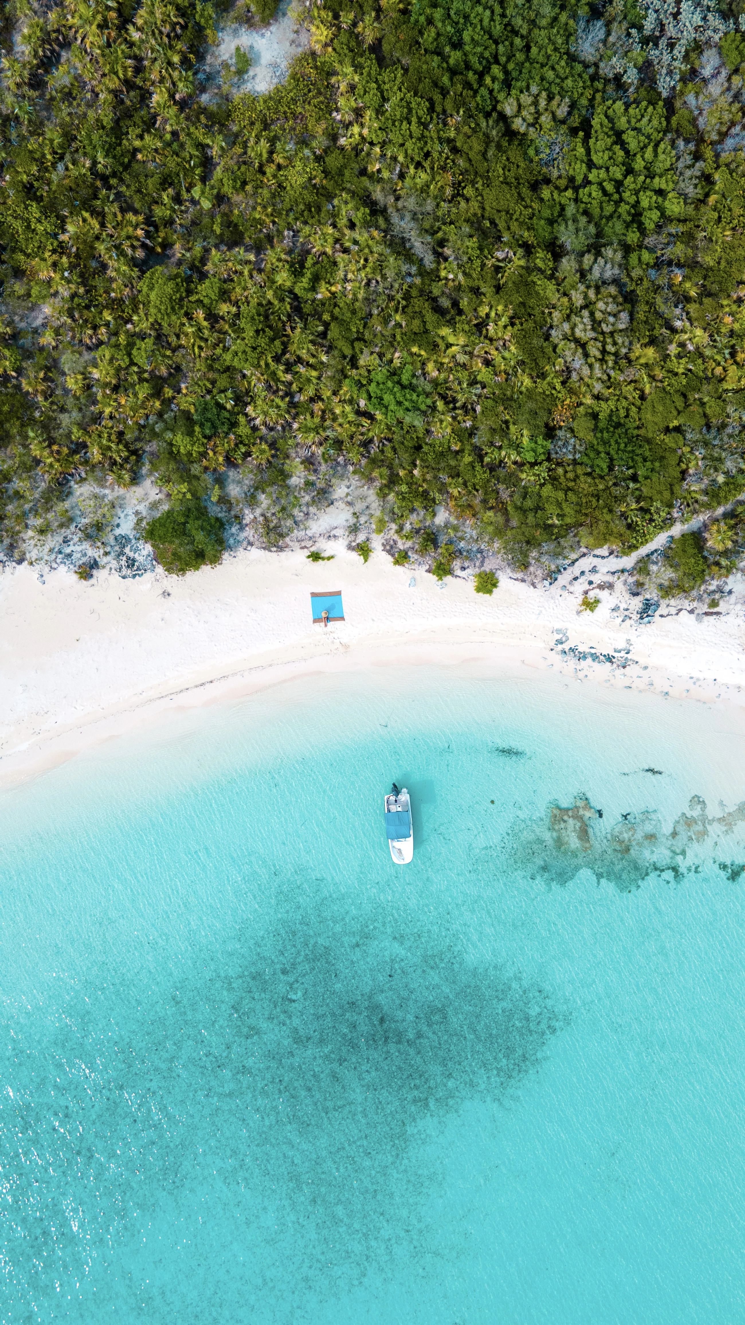 Sailboat cutting through turquoise Bahamian water
