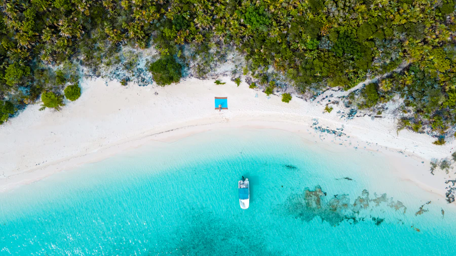 Aerial view of a white-sand cove and turquoise water in the Exumas