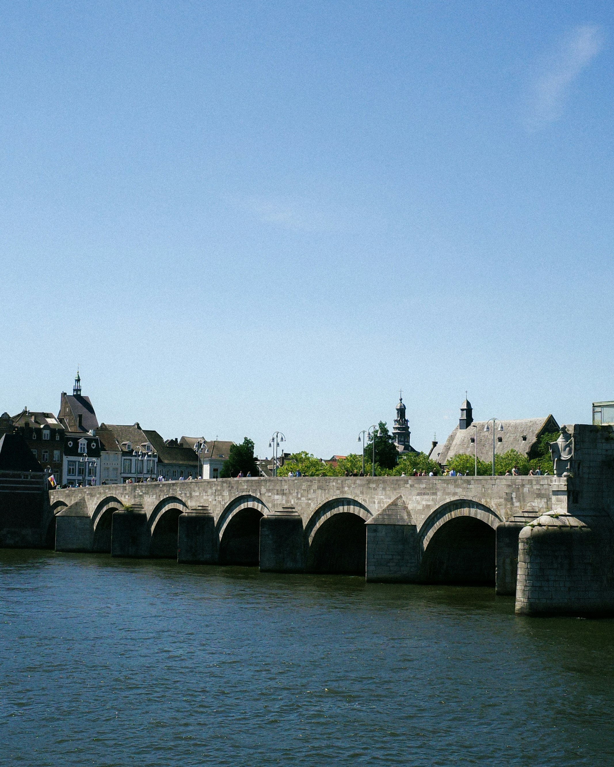 An ancient bridge spans a river.